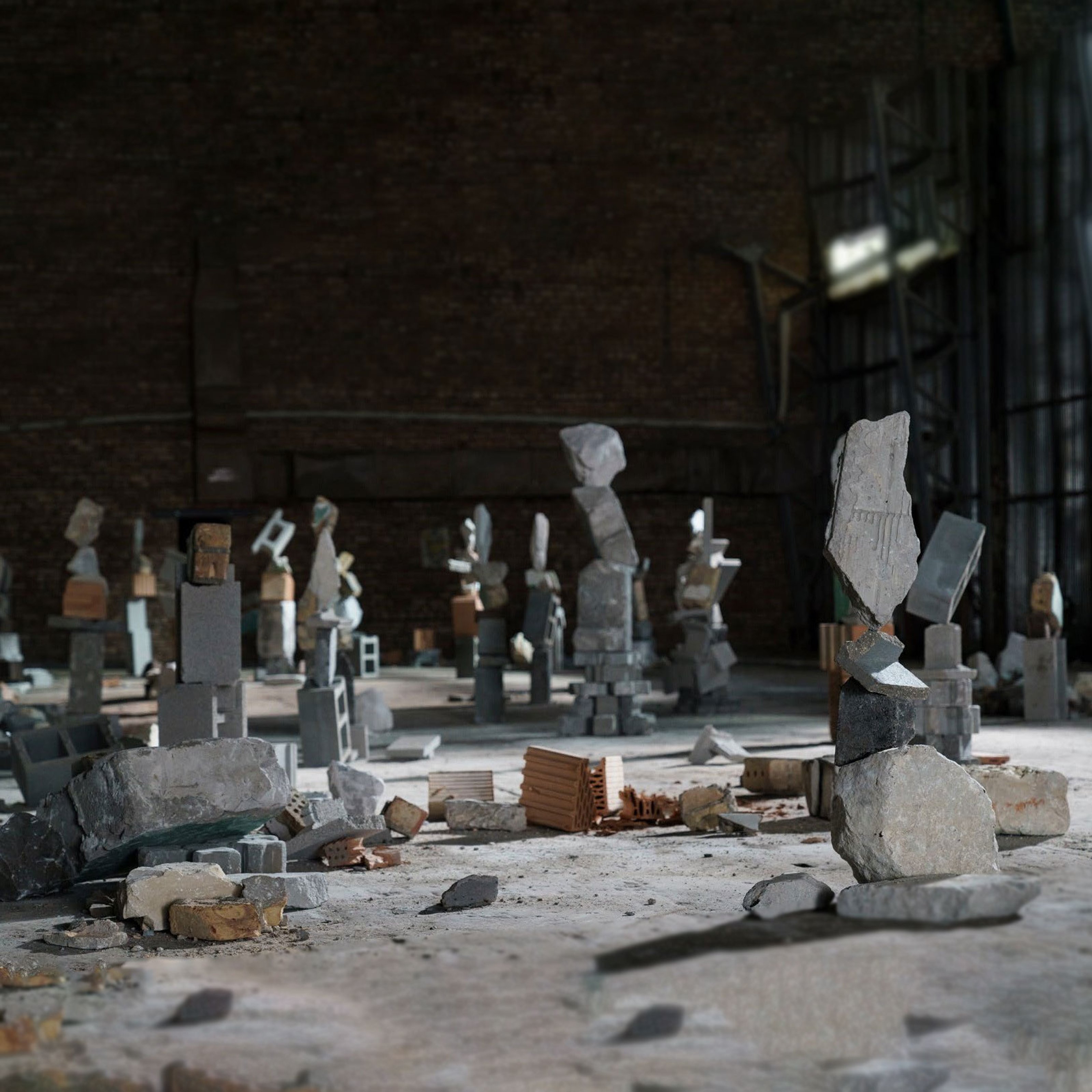 It is an installation of stones mounted one above the other, placed on the floor of an old, concrete, large space.