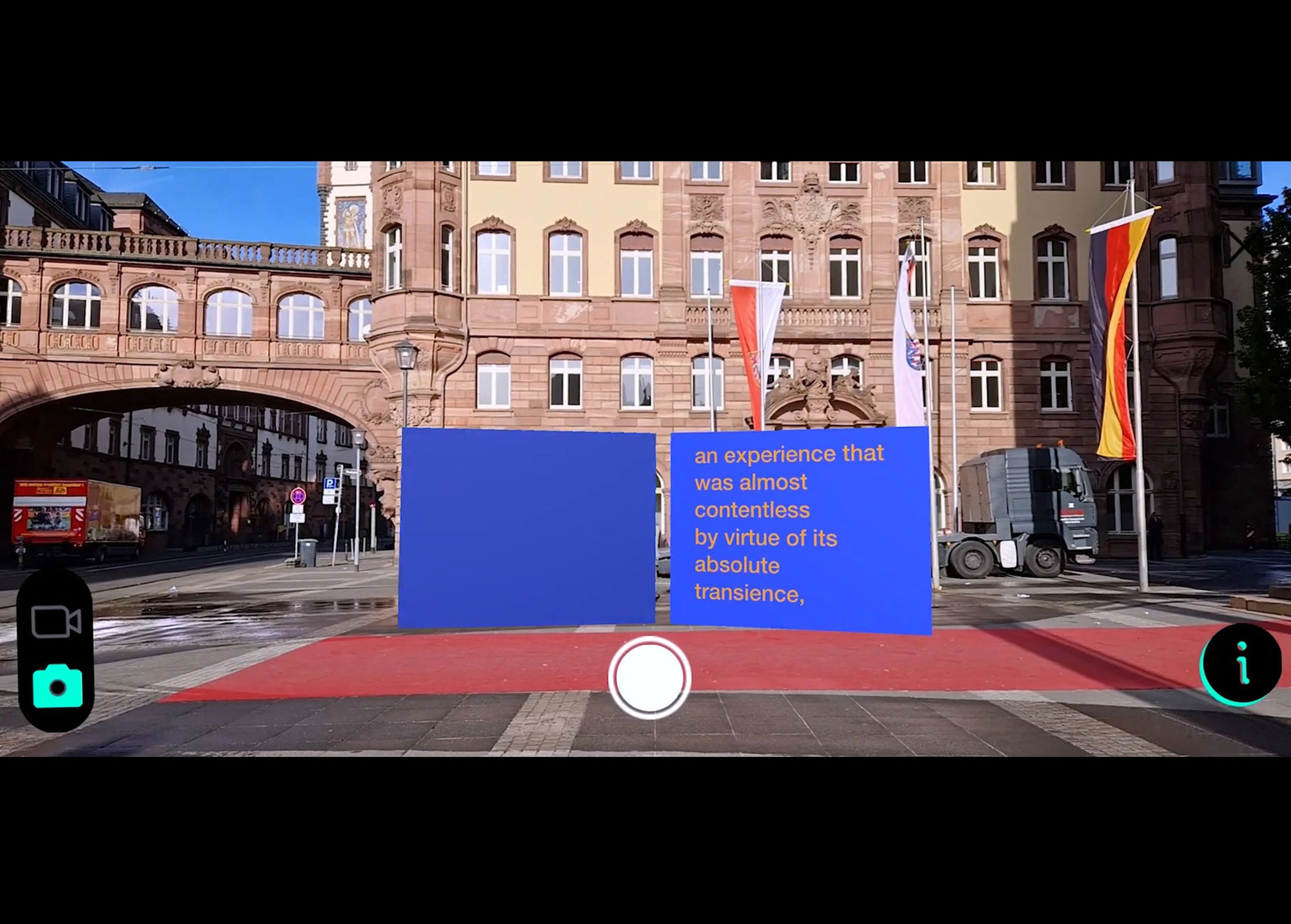 Two big AI screens placed in a square in the city, "an experience was almost contentless by virtue of its absolute transience," is written on one of them in white on bright blue color.