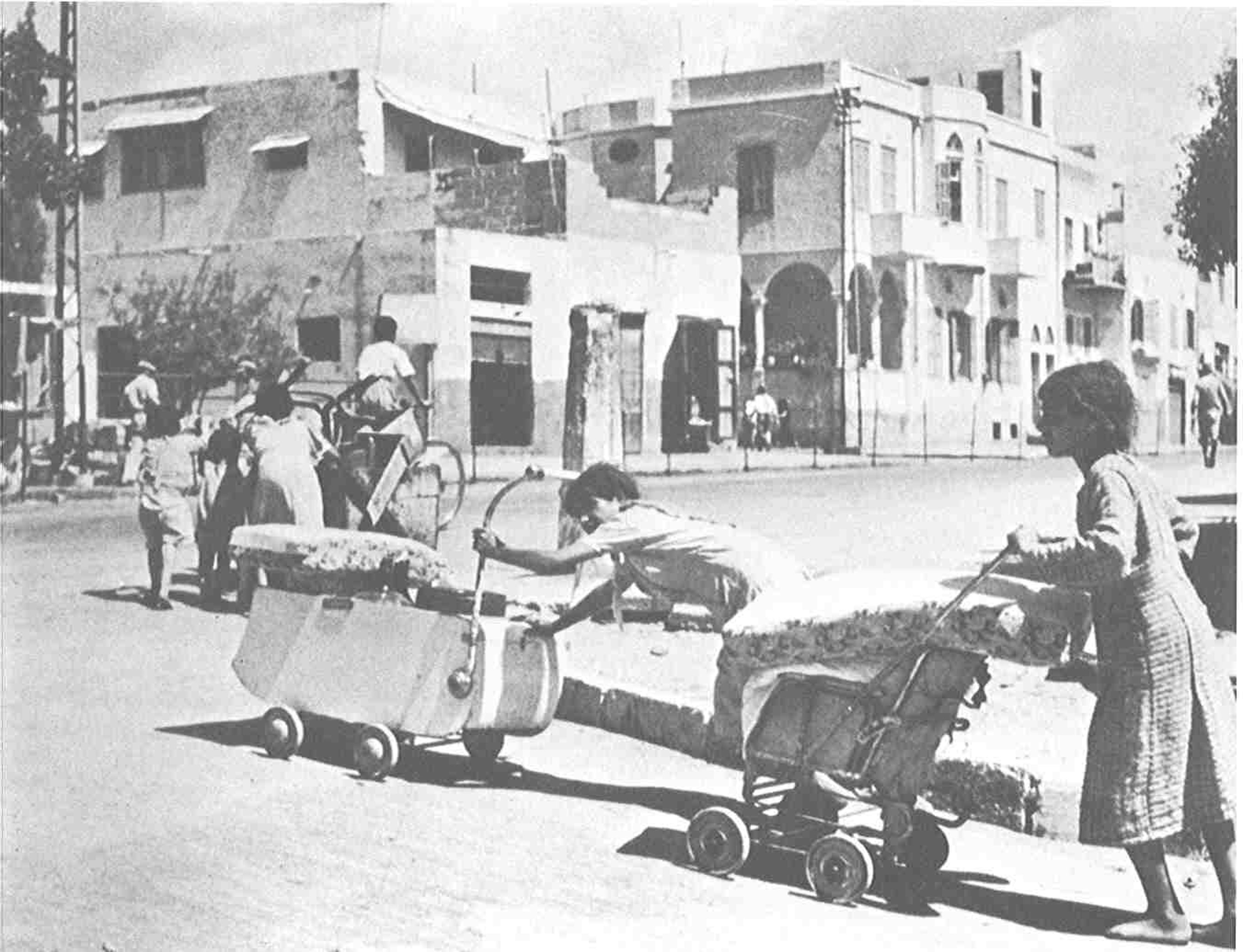 Black and white photograph of Jaffa's residents attempting to salvage whatever they can as they are being ethnically cleansed.