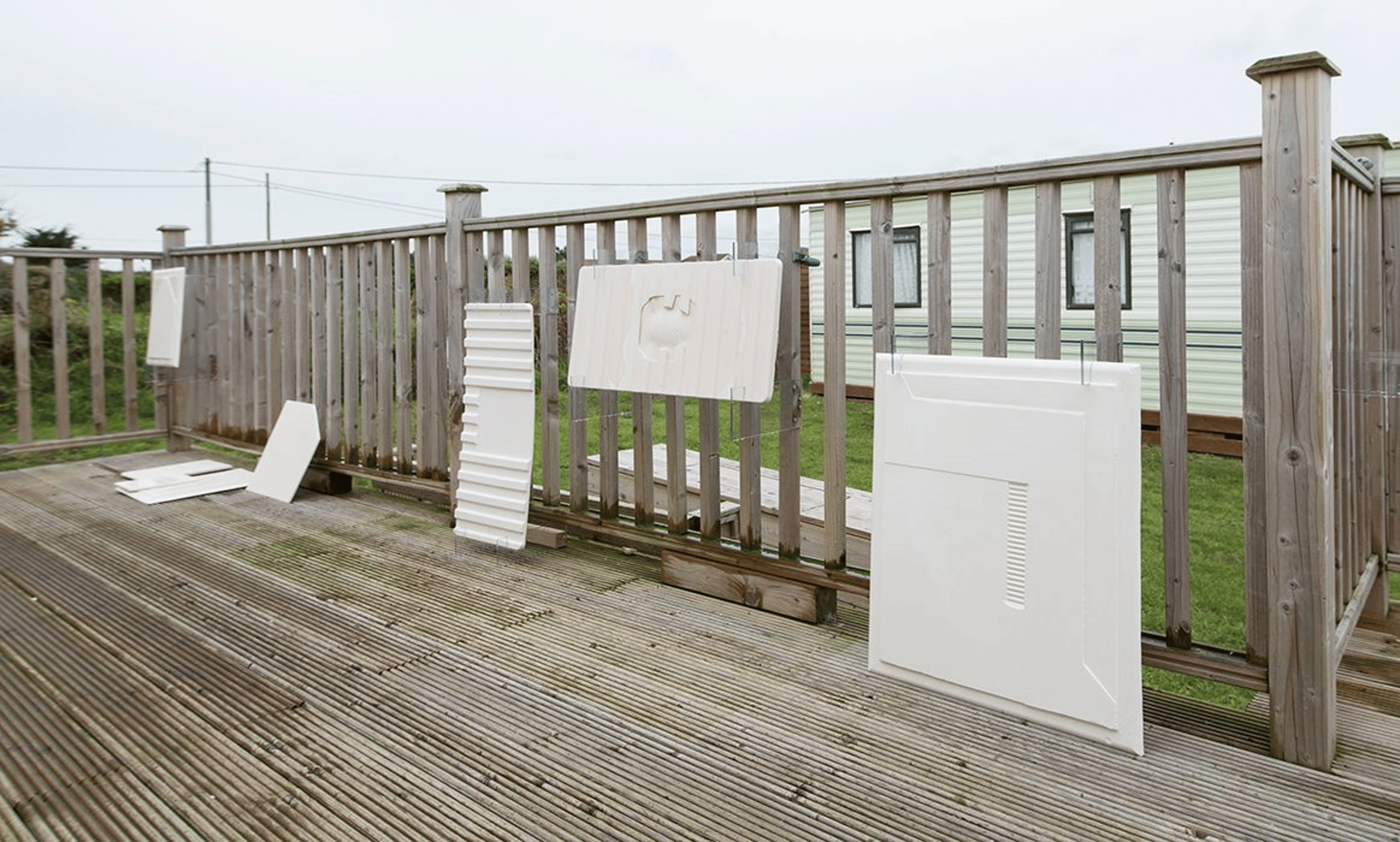 Plaster cast block leaning on a fence