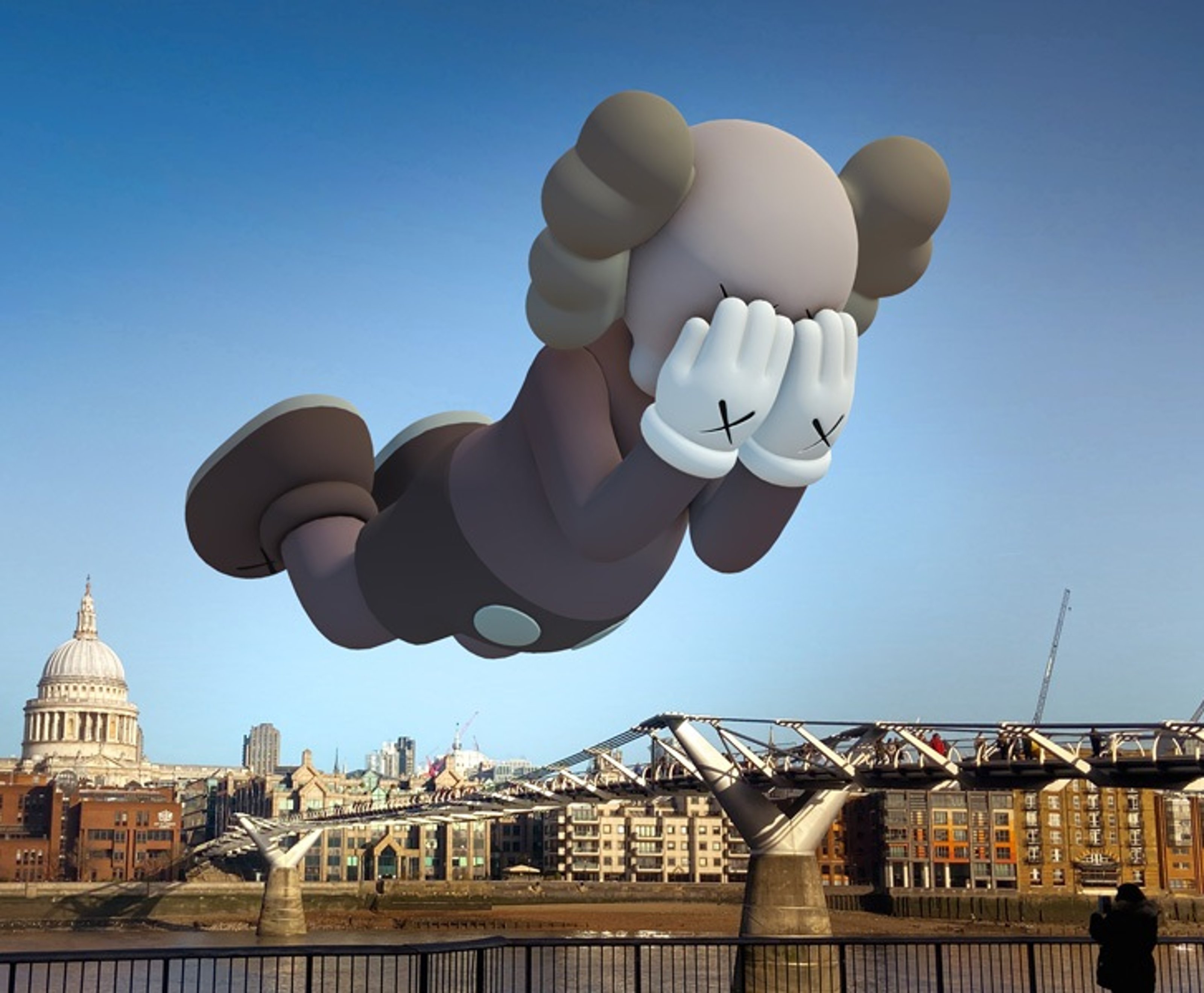 KAWS companion brown figure virtually floating over city.