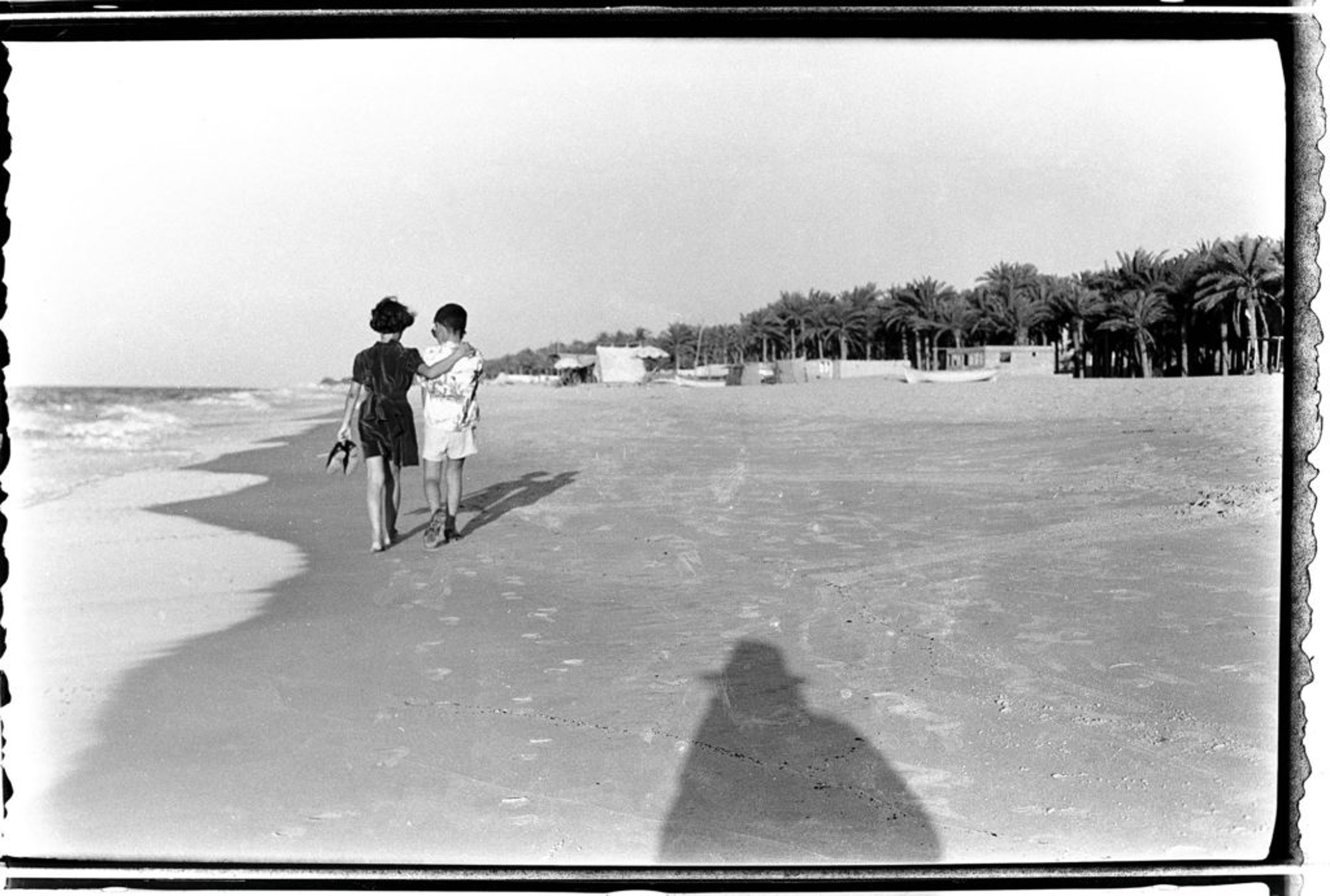 Djeghalian’s favourite photo by his grandfather shows two children walking along Gaza’s beach. They are perhaps five or six years old—his aunt and his father. In the foreground, one sees the photographer’s shadow, like a guardian angel. Image source: Hadara Magazine. Courtesy of Kegham Djeghalian.