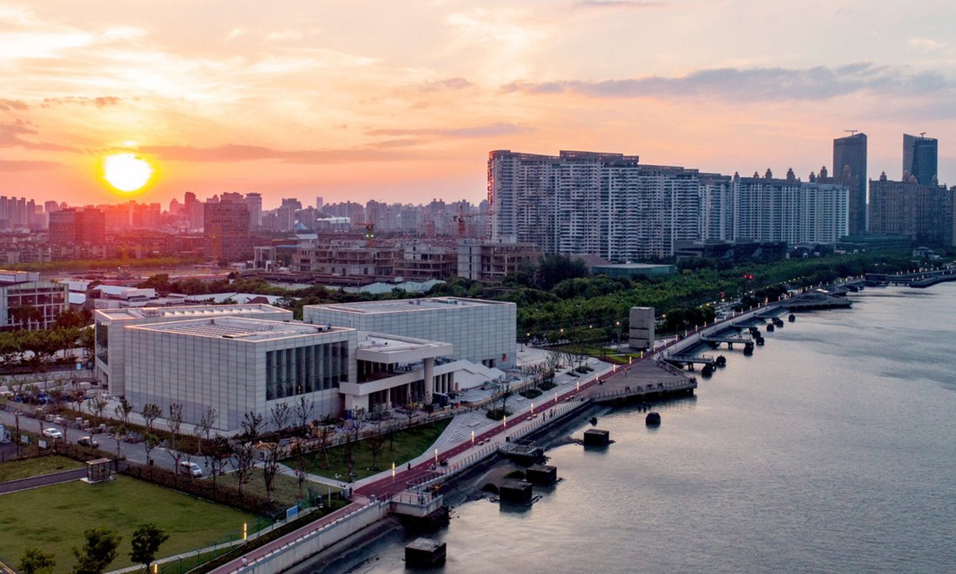 Wide angle view of the West Bund Museum in Shanghai from the outside at sunset.