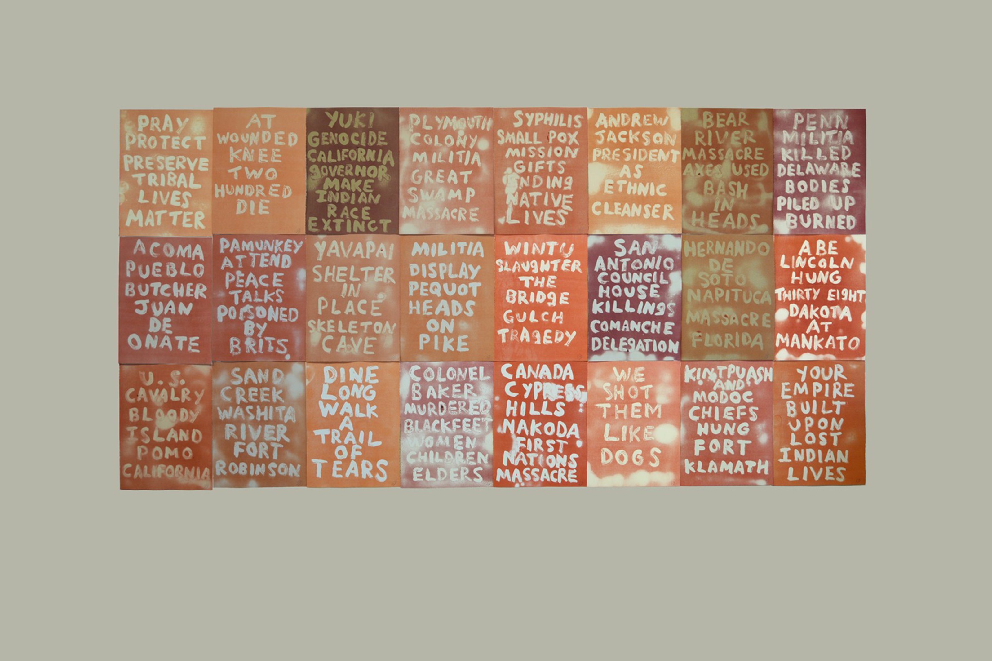 A large artwork composed of 24 ghost prints with words written in various shades of red and orange, addressing historical injustices against Indigenous peoples.