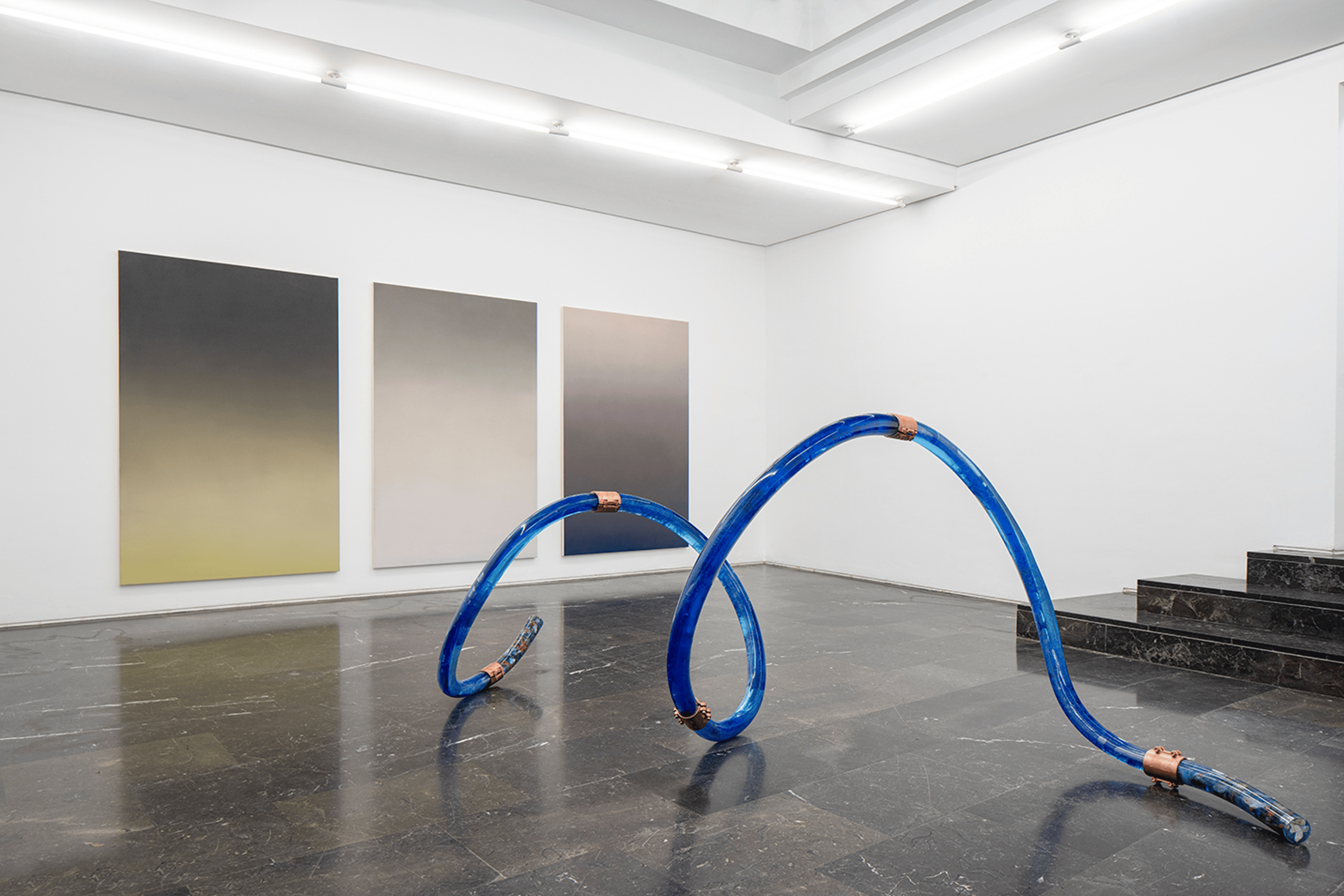 Blue spiral tube in a gallery space