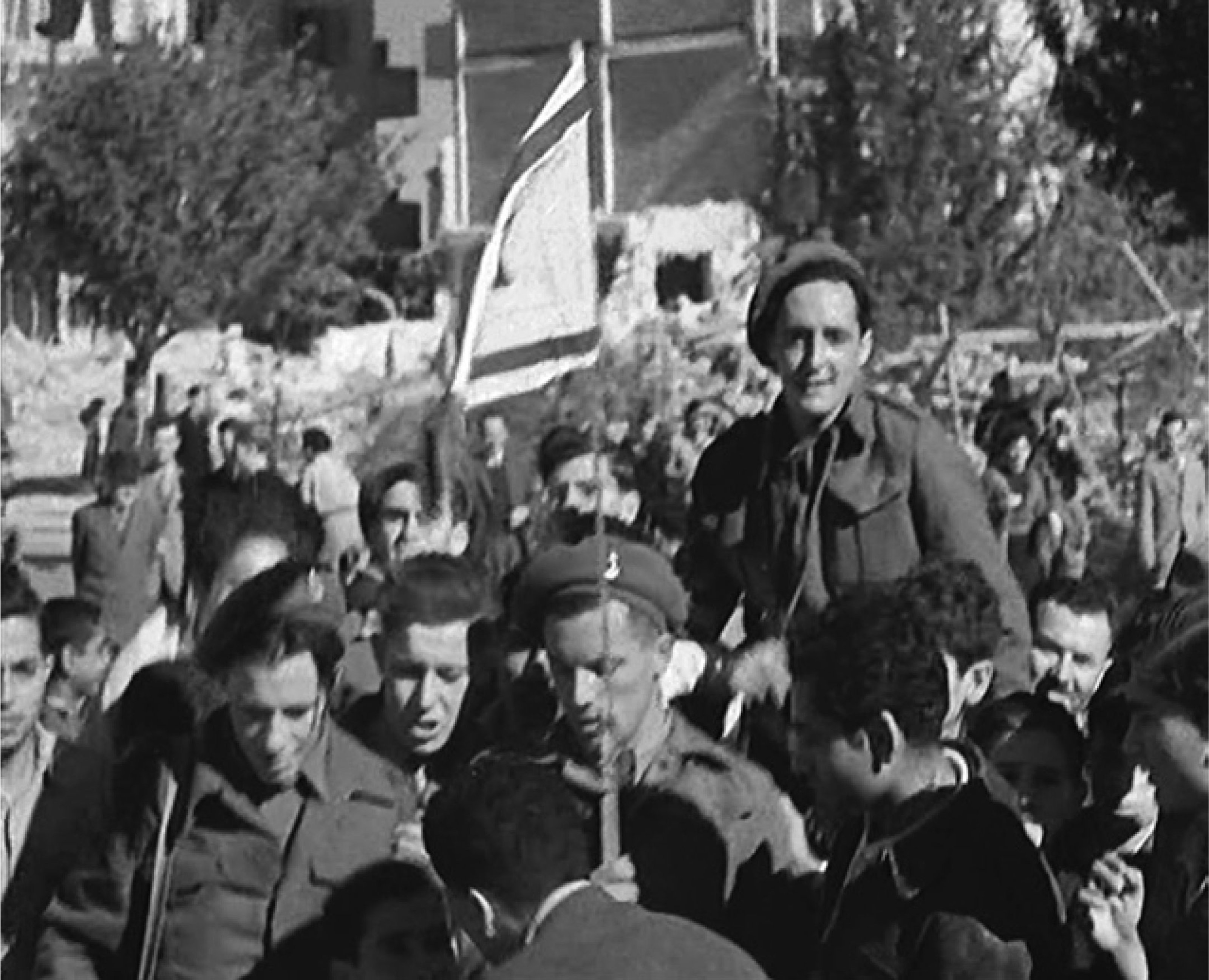 Still showing British troops among a group with the Zionist flag celebrating the UN partition resolution from The Arabs Declare Holy War (1947). Image supplied by British Pathé.