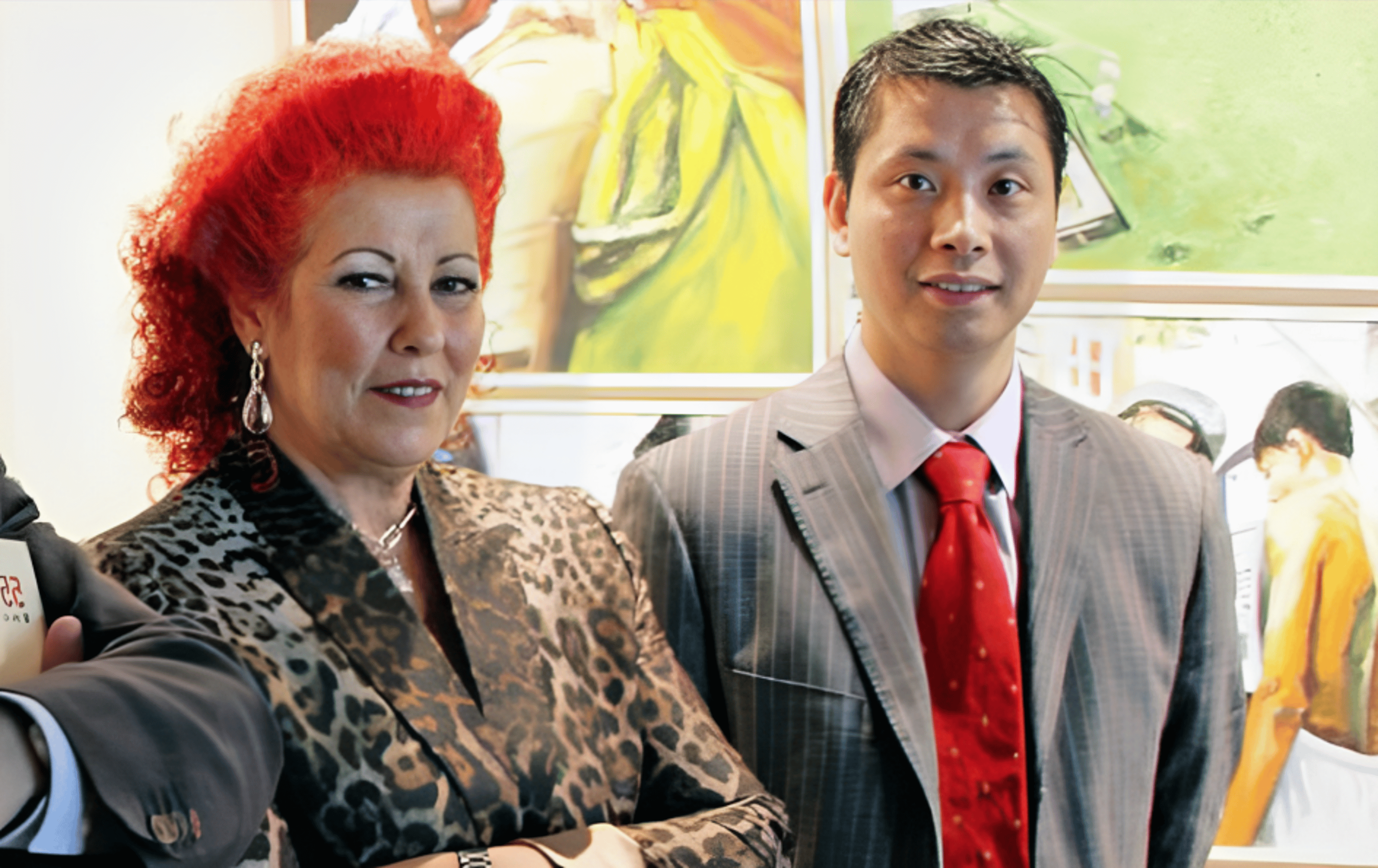 Middle-aged woman with red wavy hair in leopard print jacket, Consuelo Ciscar, with young, striped jacket, short shiny hair Gao Ping.