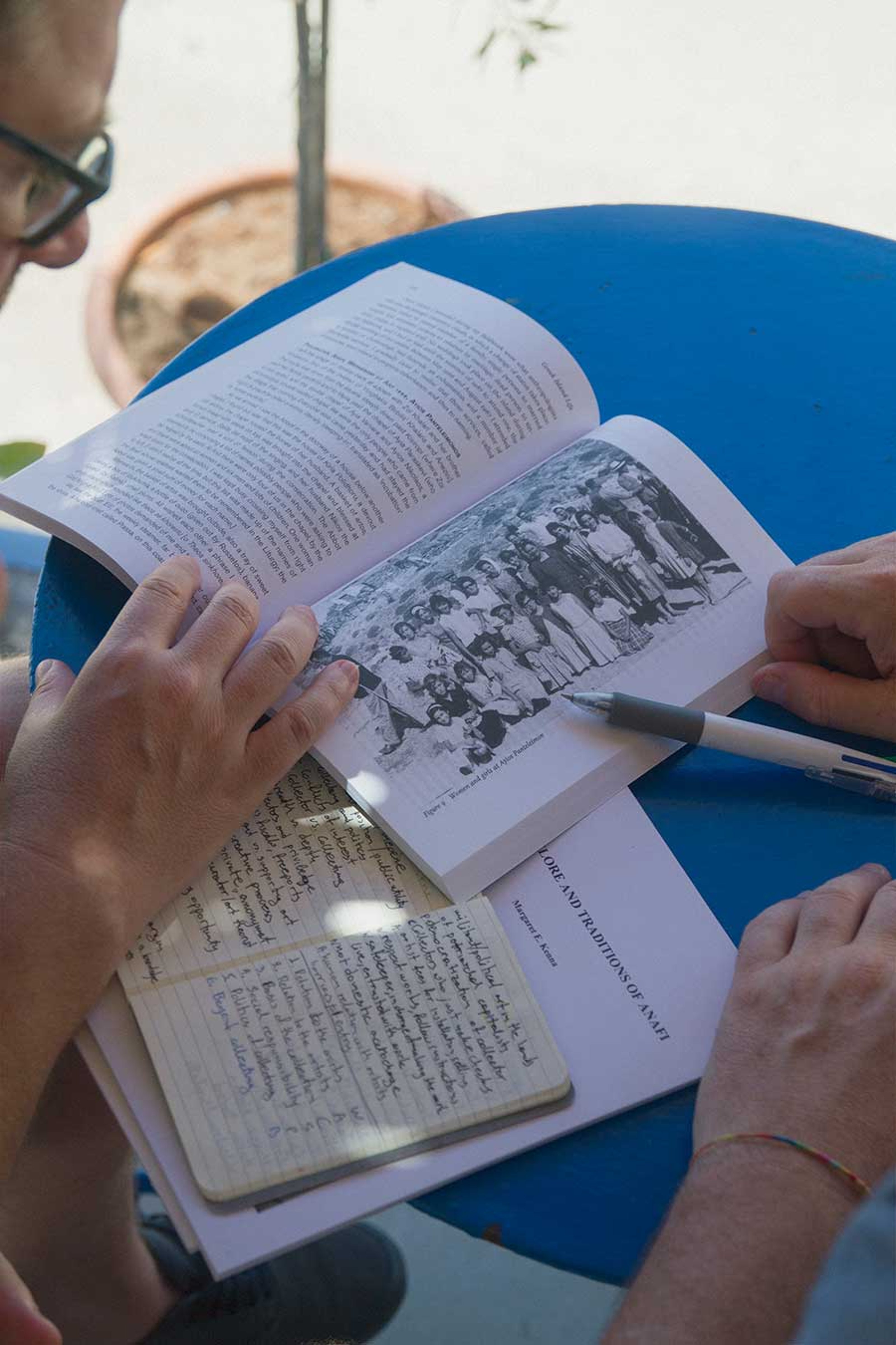 Kerenidis and Pepe looking through documents and a book on Anafi