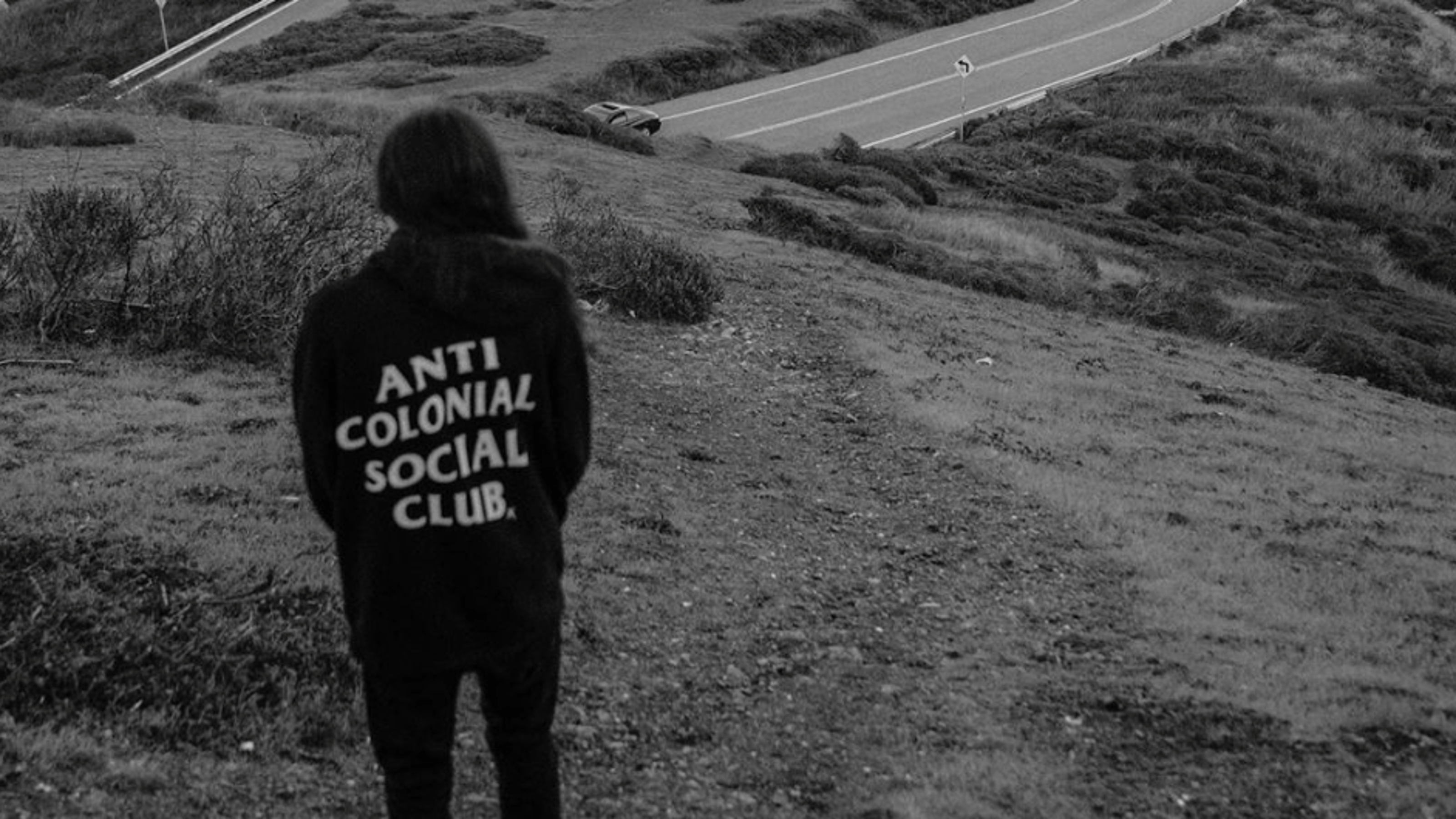 Xiuhtezcatl posing backwards with a jacket that says Anti Colonial Social Club