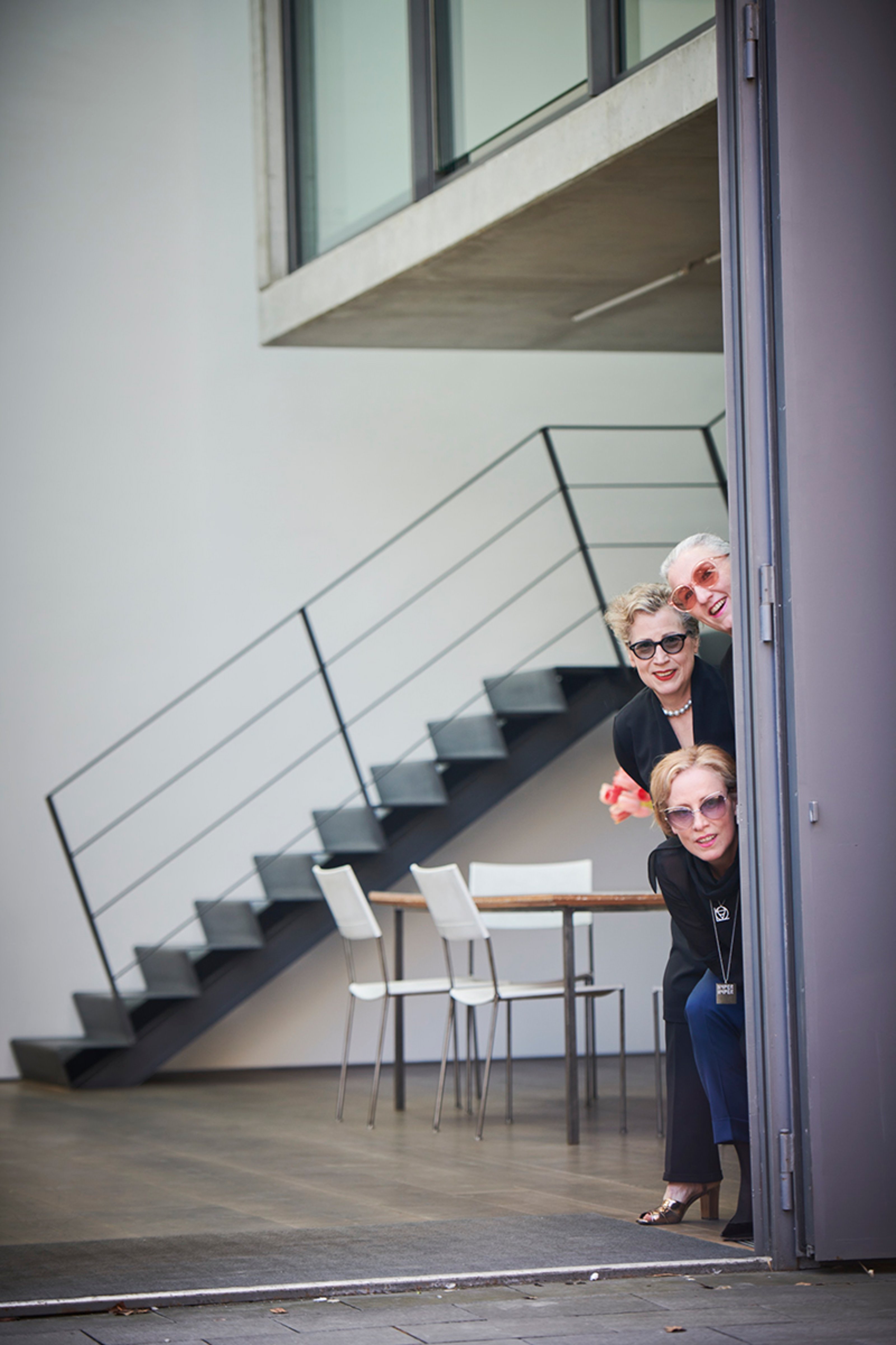 Bärbel and Sabine and Karola Kraus peeking out from behind the door at Graesslin Collection