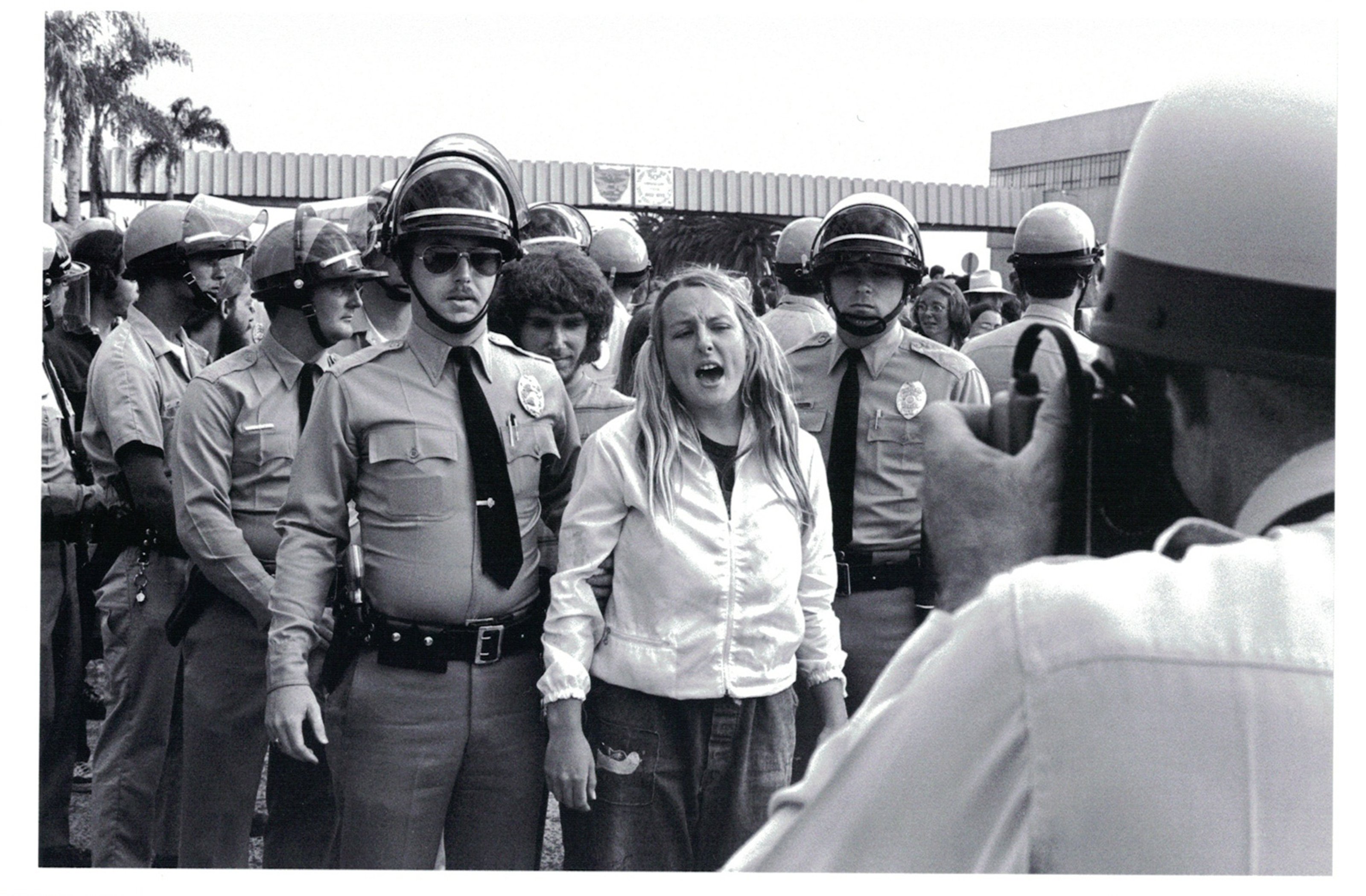 Police arresting a protester who is captured yelling at a Vietnam protest.