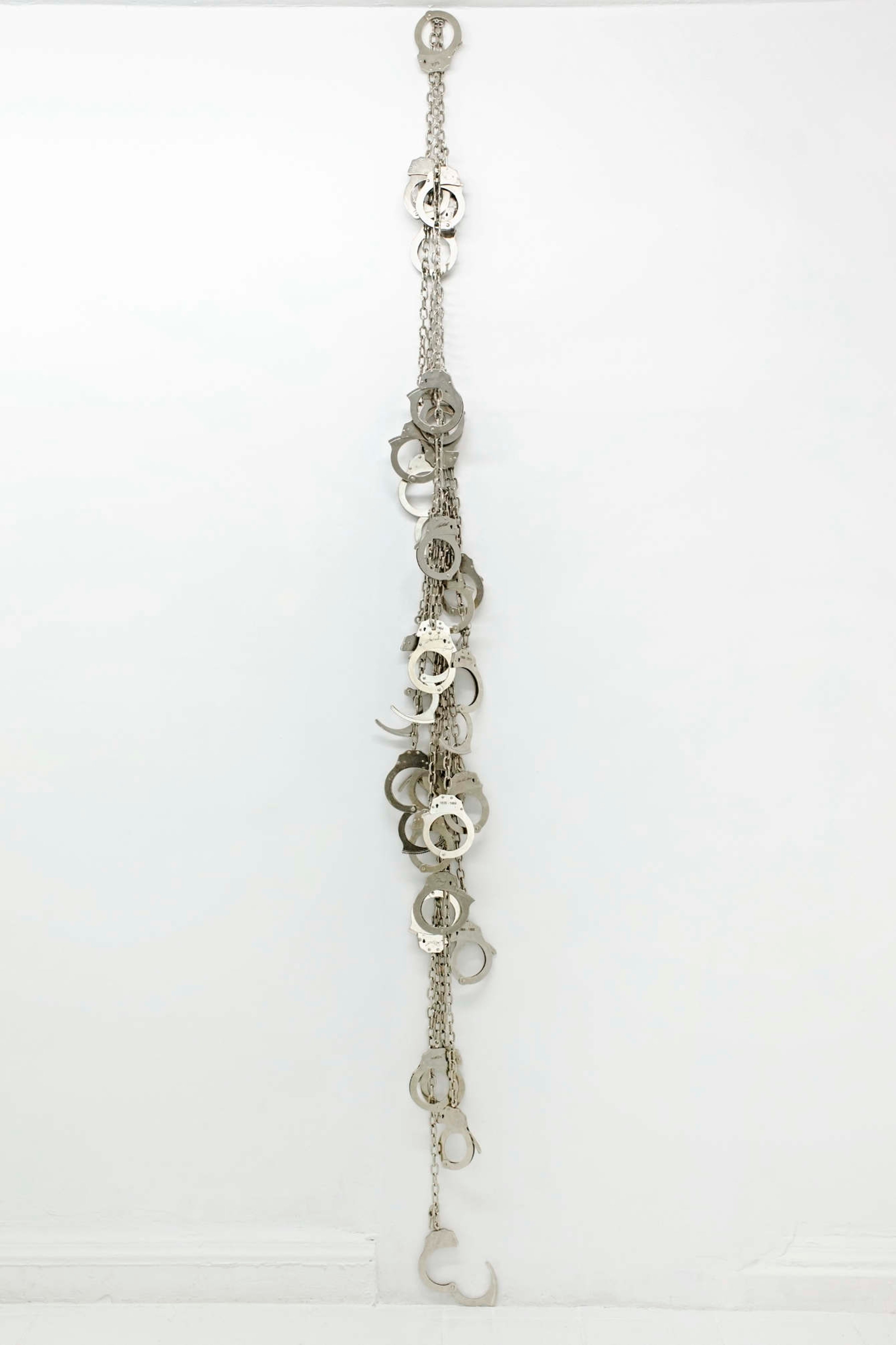 Gabriella Torres Ferrer, Auditoría (Totem), 2018 15 suspended stainless steel leg cuffs, 9.75 feet x 8 inches