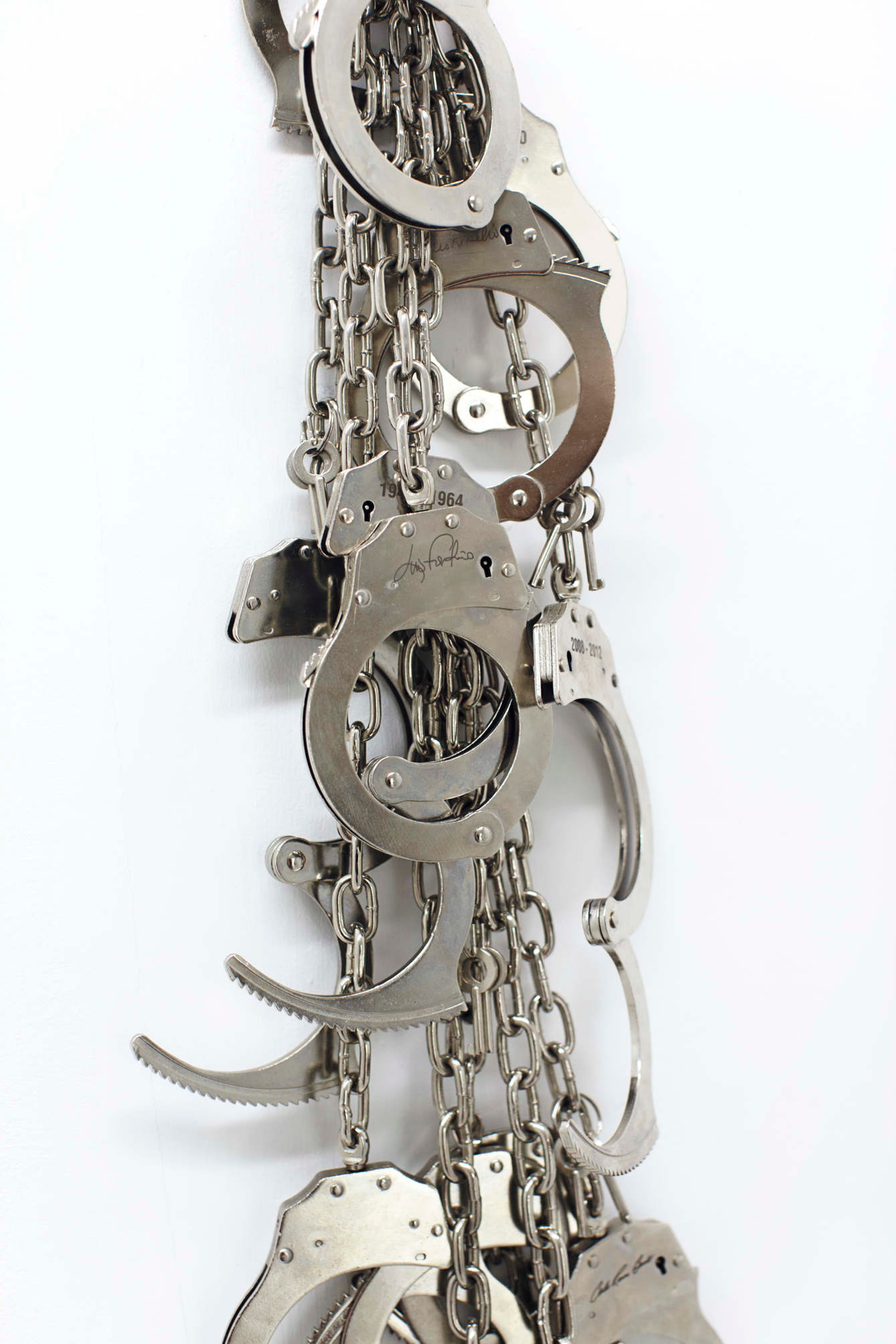 Gabriella Torres Ferrer, Auditoría (Totem), 2018 15 suspended stainless steel leg cuffs, 9.75 feet x 8 inches (DETAIL)