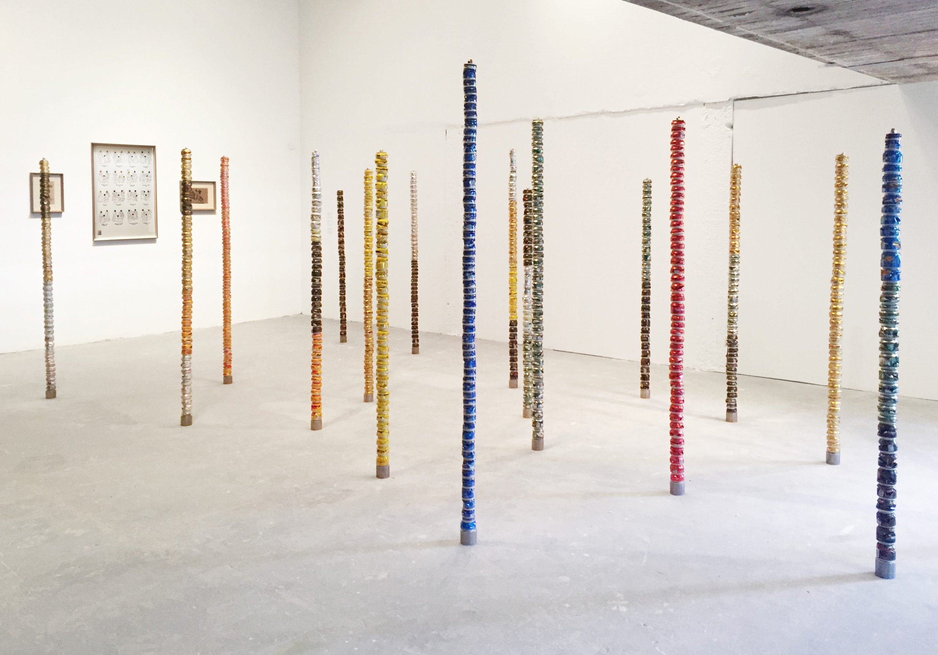 Towers built by crushed beer cans, in a gallery setting