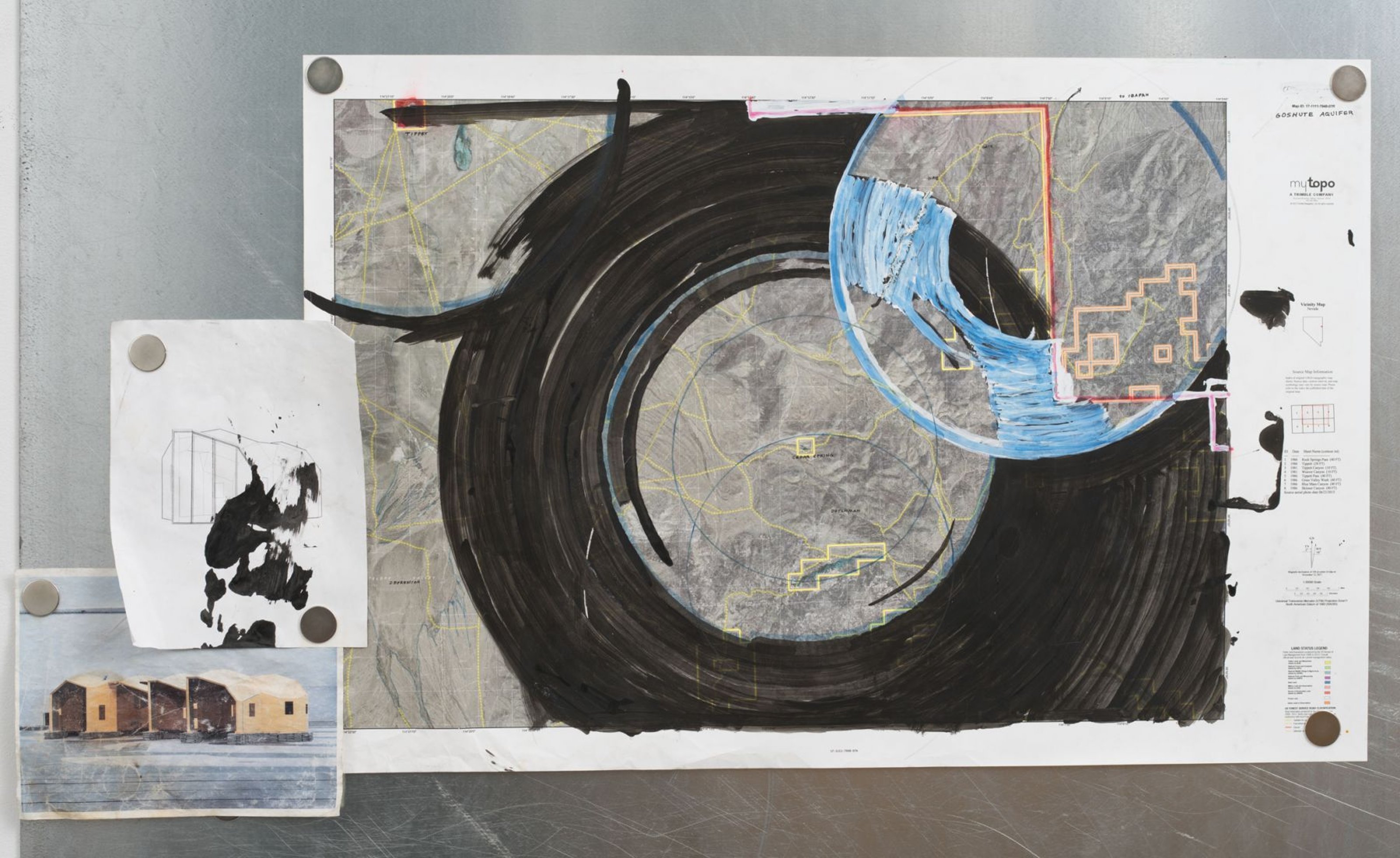 Assemblage of plans for a water school, paint on topographic map 