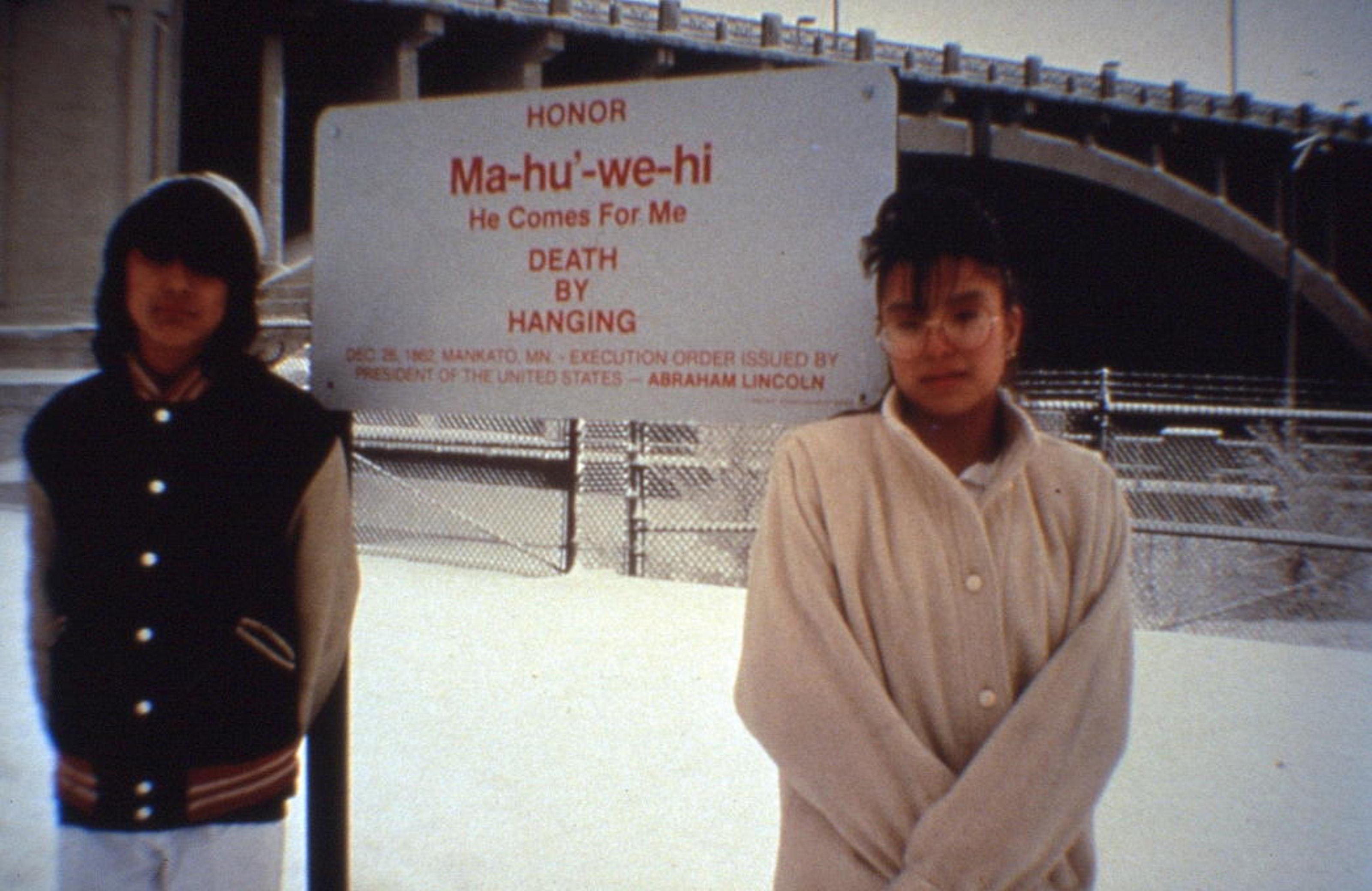 Local students posing with a sign installed for Edgar Heap of Birds - Building Minnesota. On the sign it reads: 