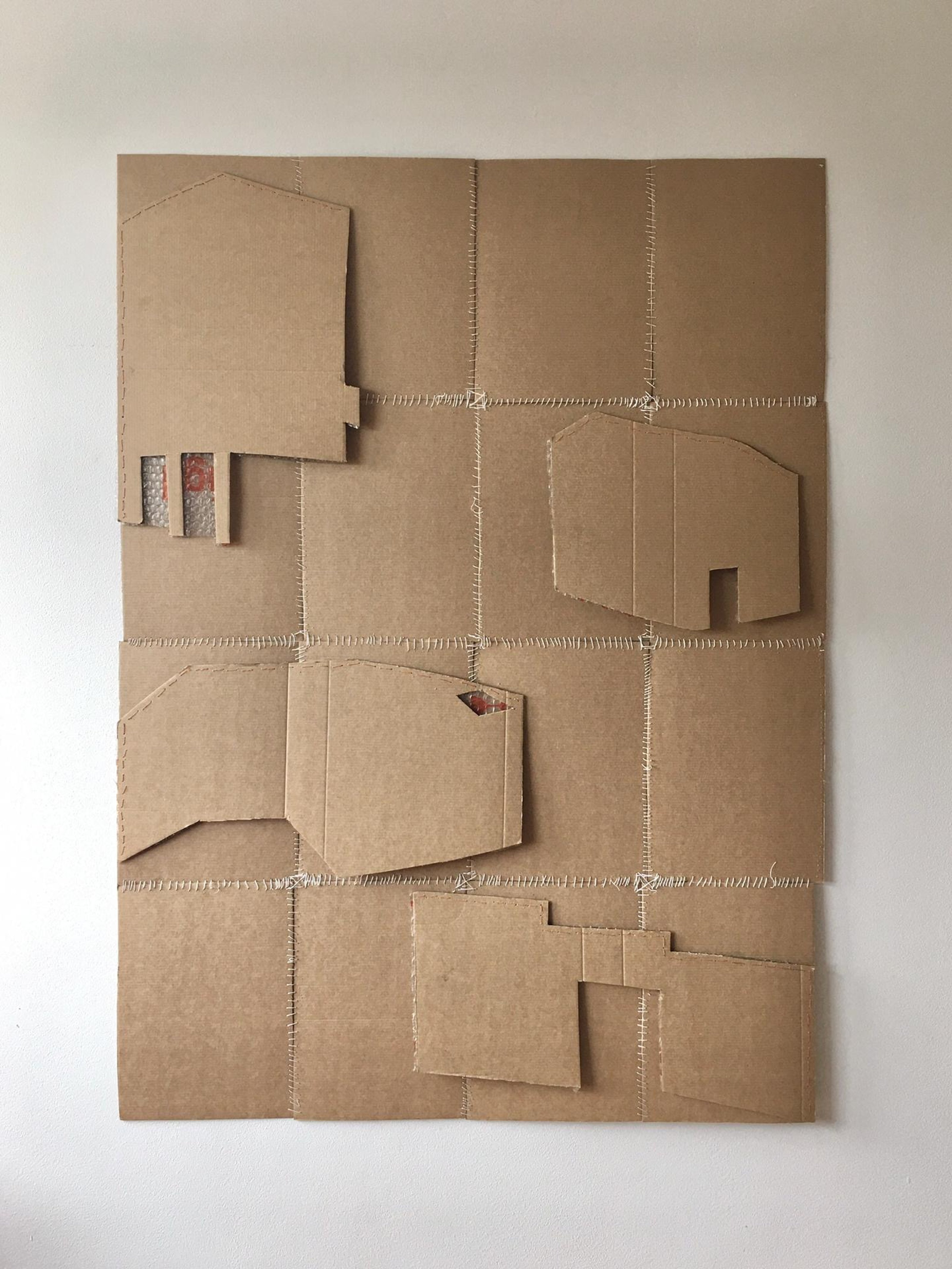 Cardboard box patchwork with cutout images of houses
