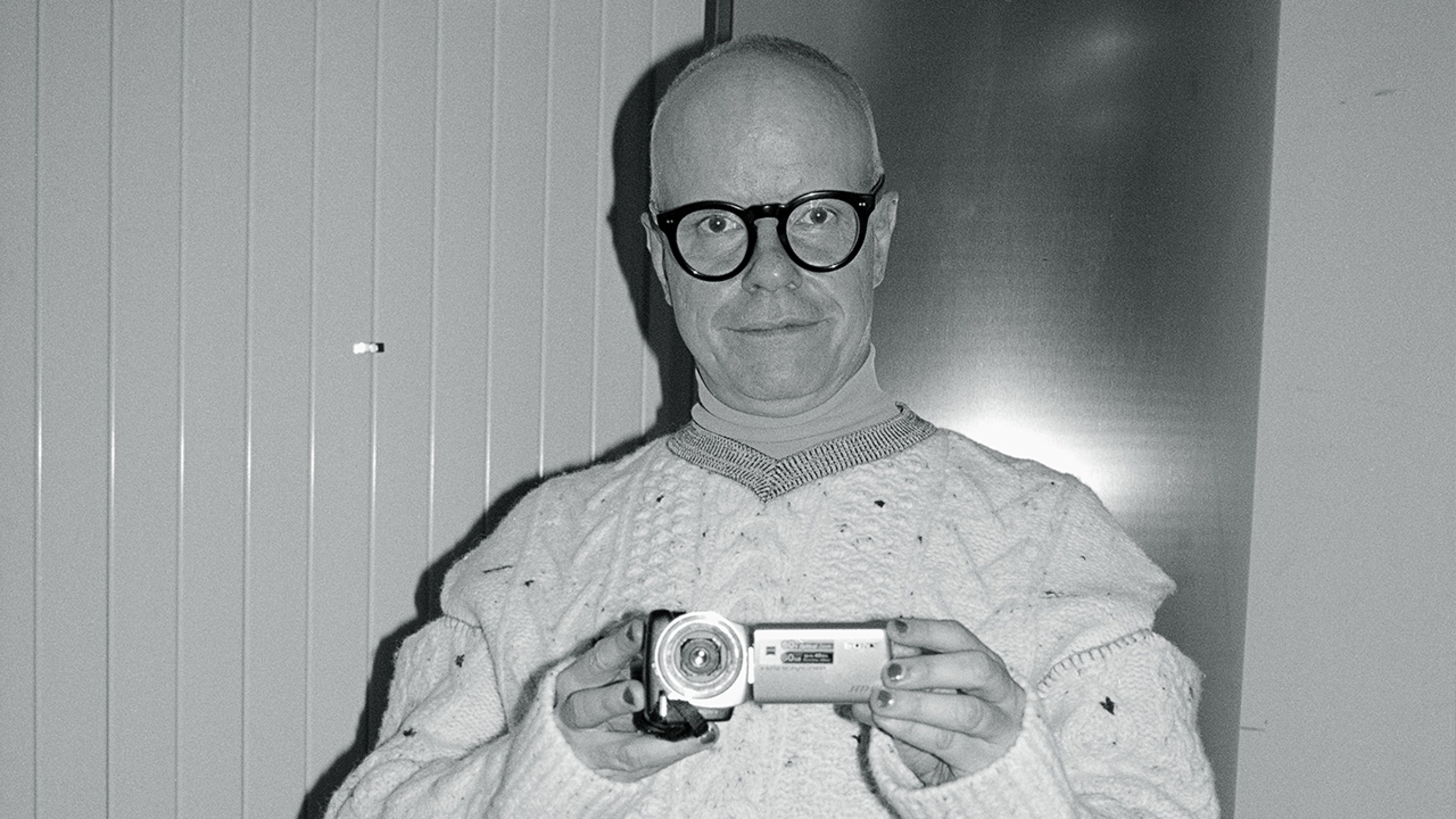Hans Ulrich Obrist. Obrist is holding a video camera in the photo