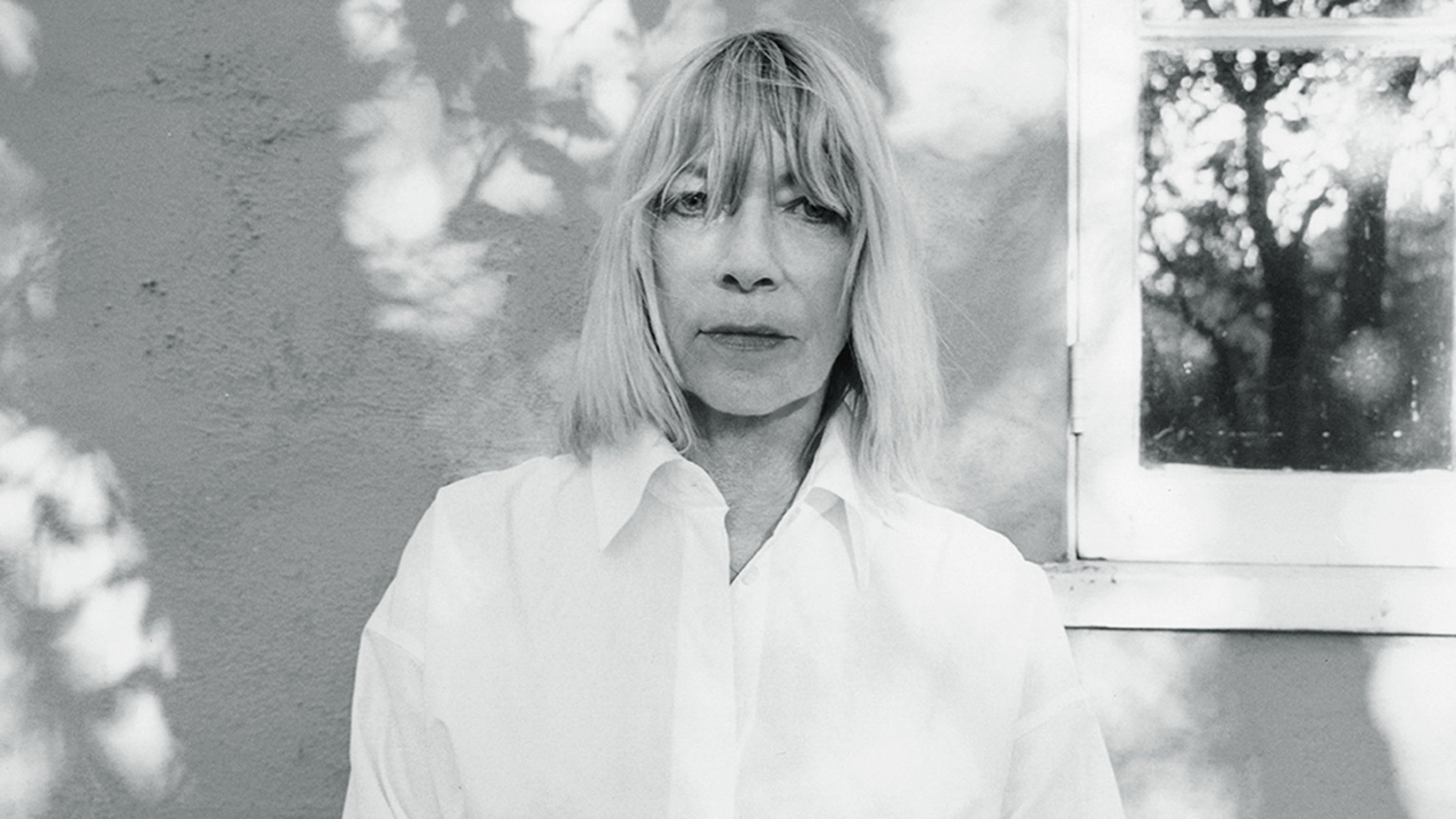 Black and white image of Kim Gordon looking into the camera