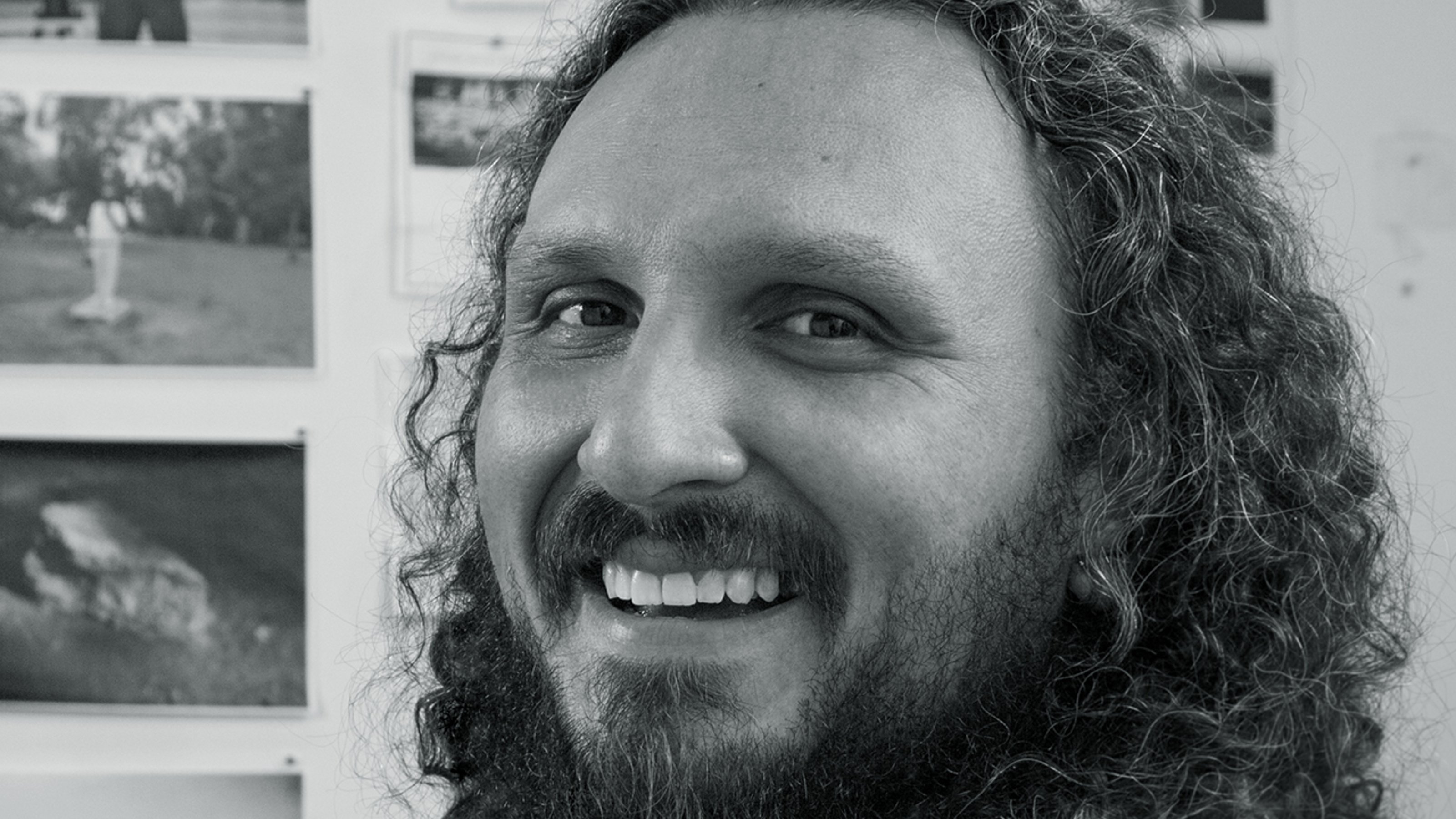 Black and white close-up of Mario Ybarra, Jr. laughing