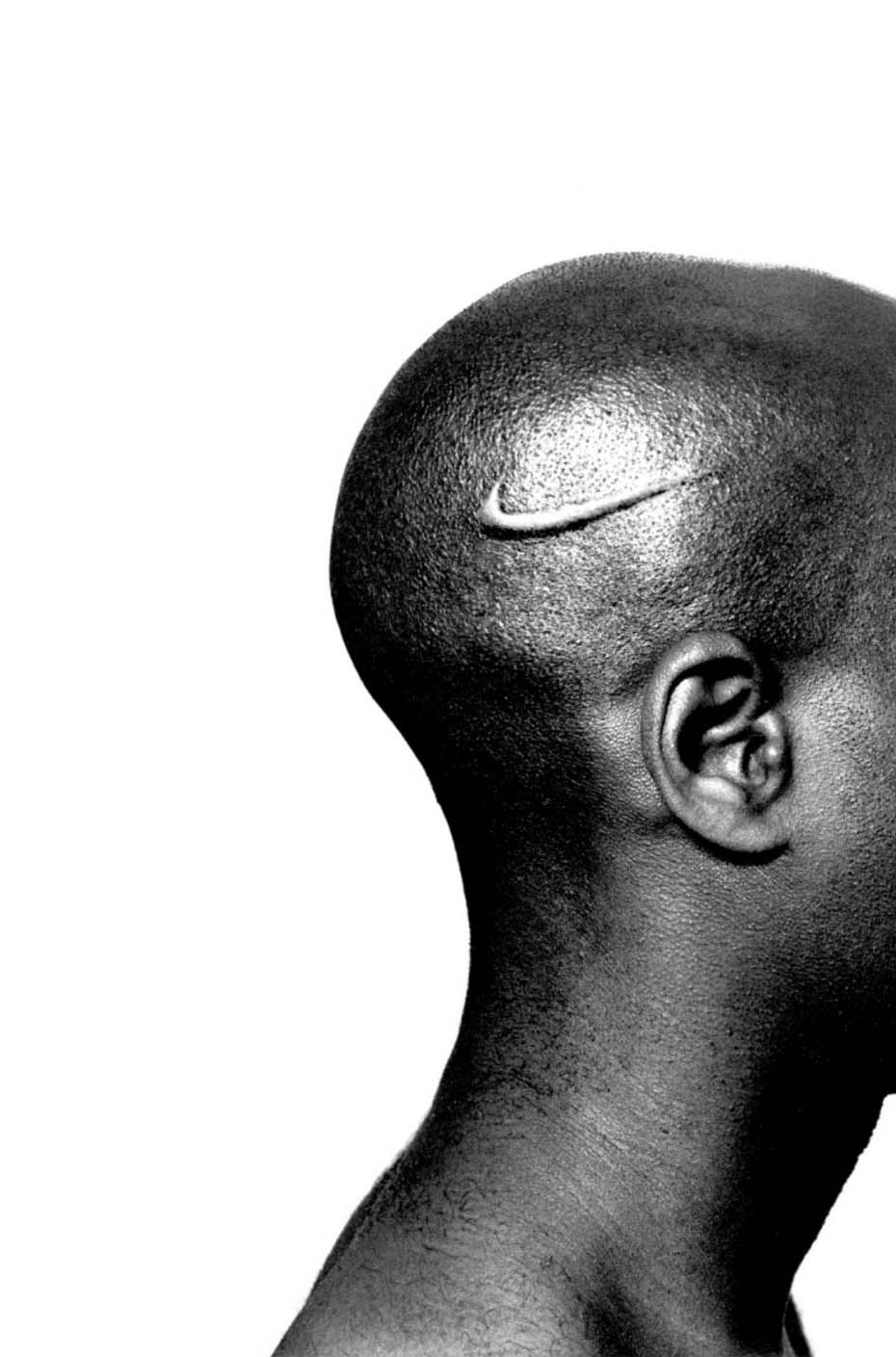 The head profile of a black man branded with a Nike logo