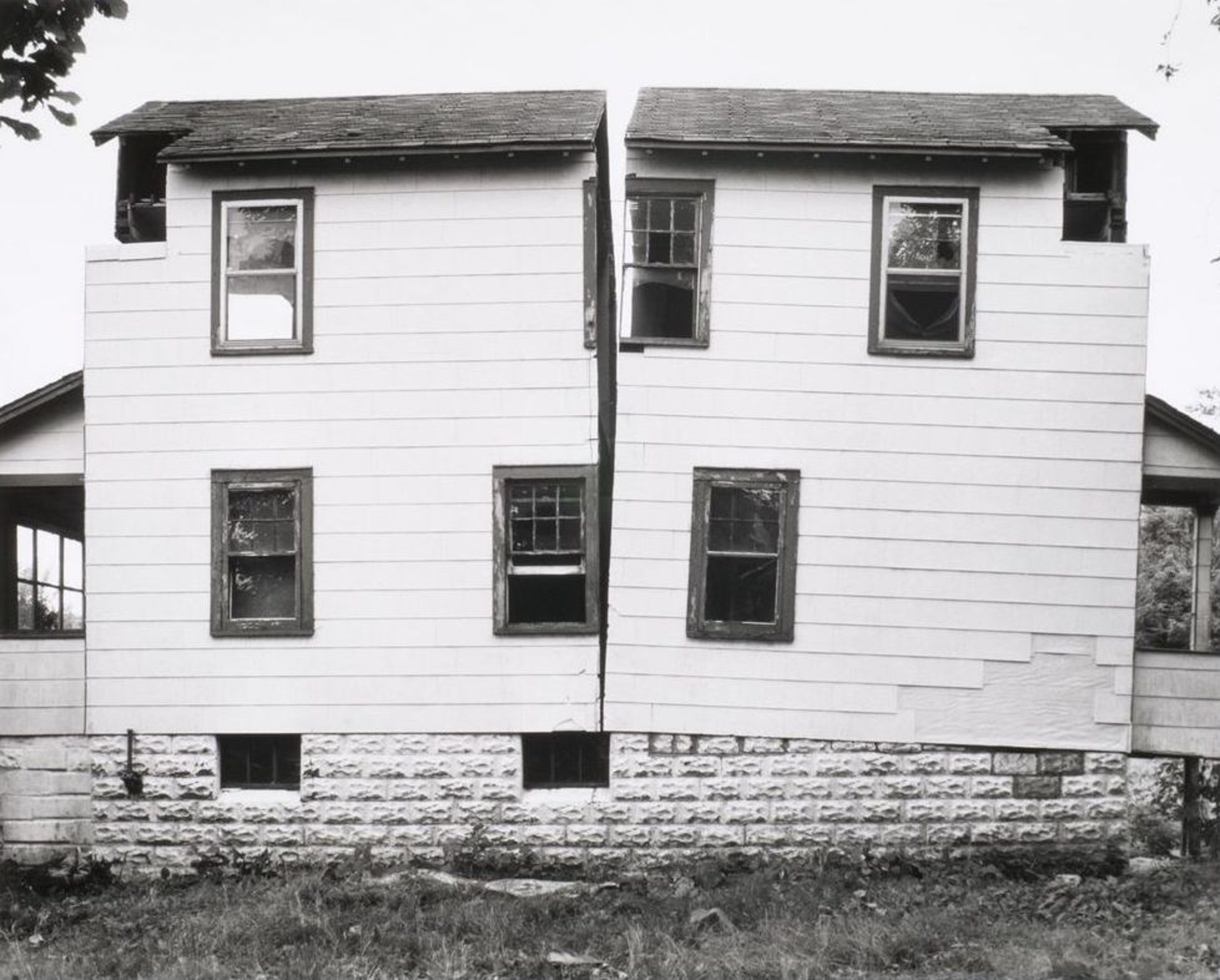 A white country single house is split vertically in half at the middle.