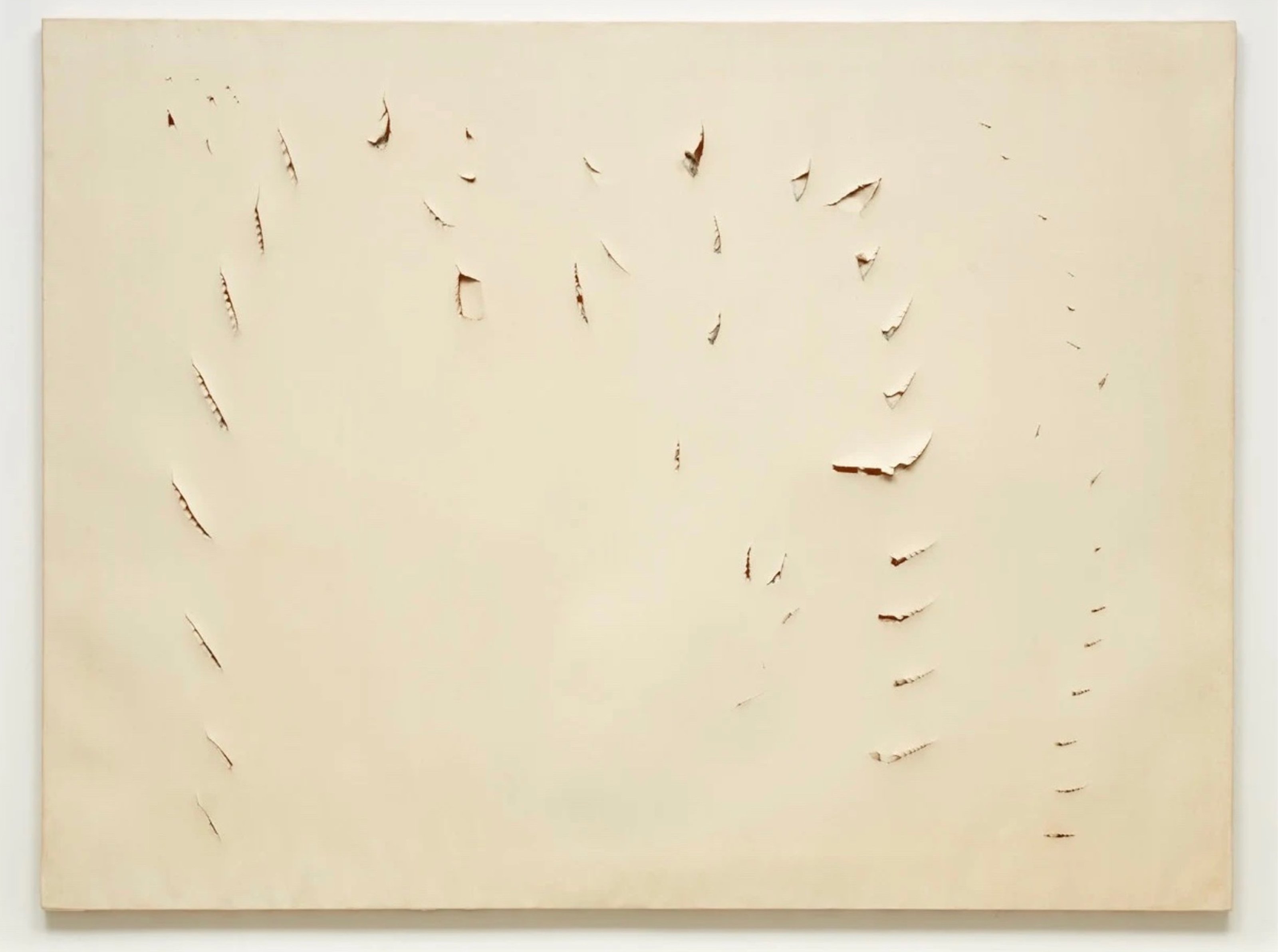 A piece of beige paper with over 40 stab marks.