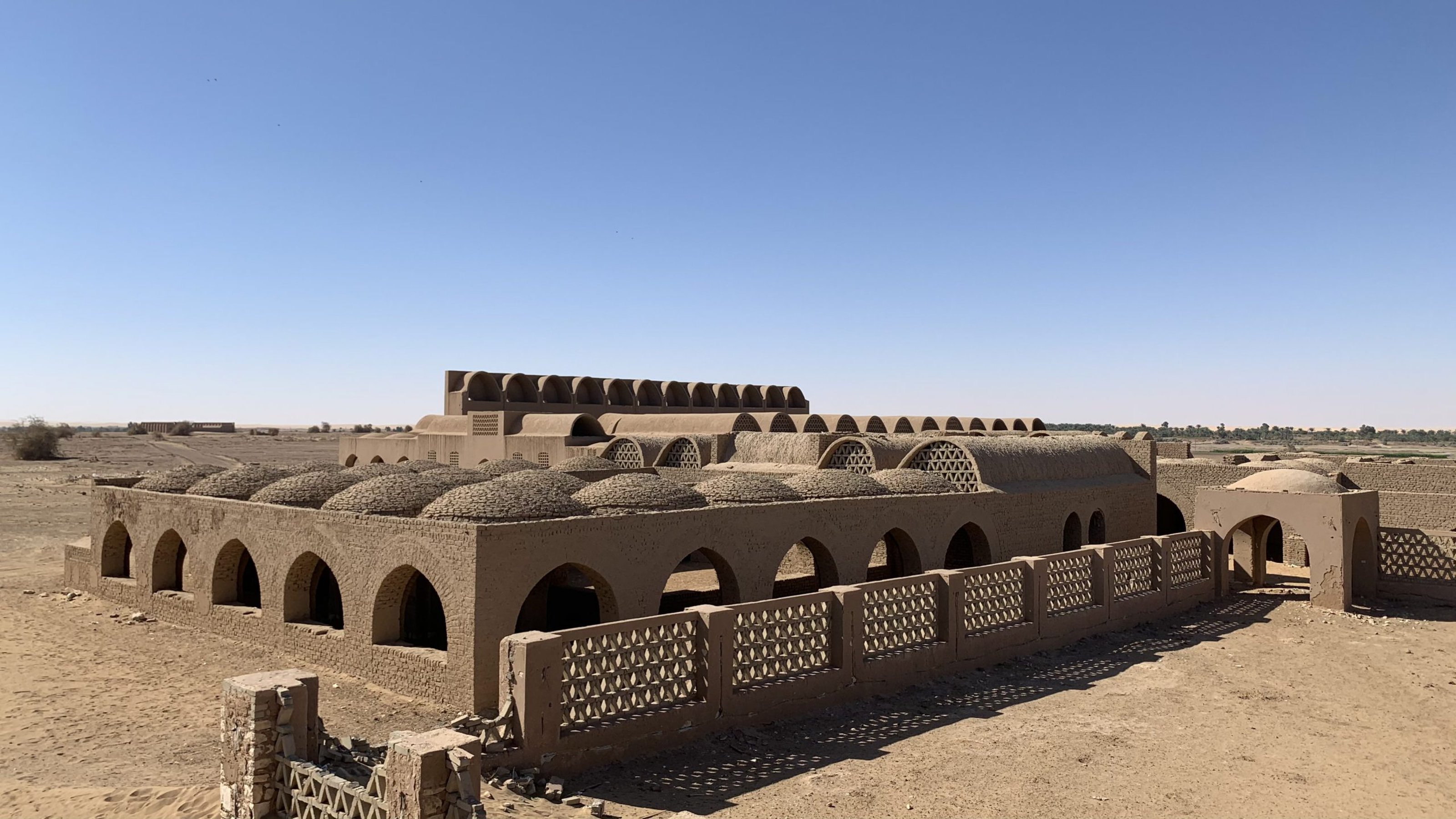 Historical building with domes and arches, located in the desert
