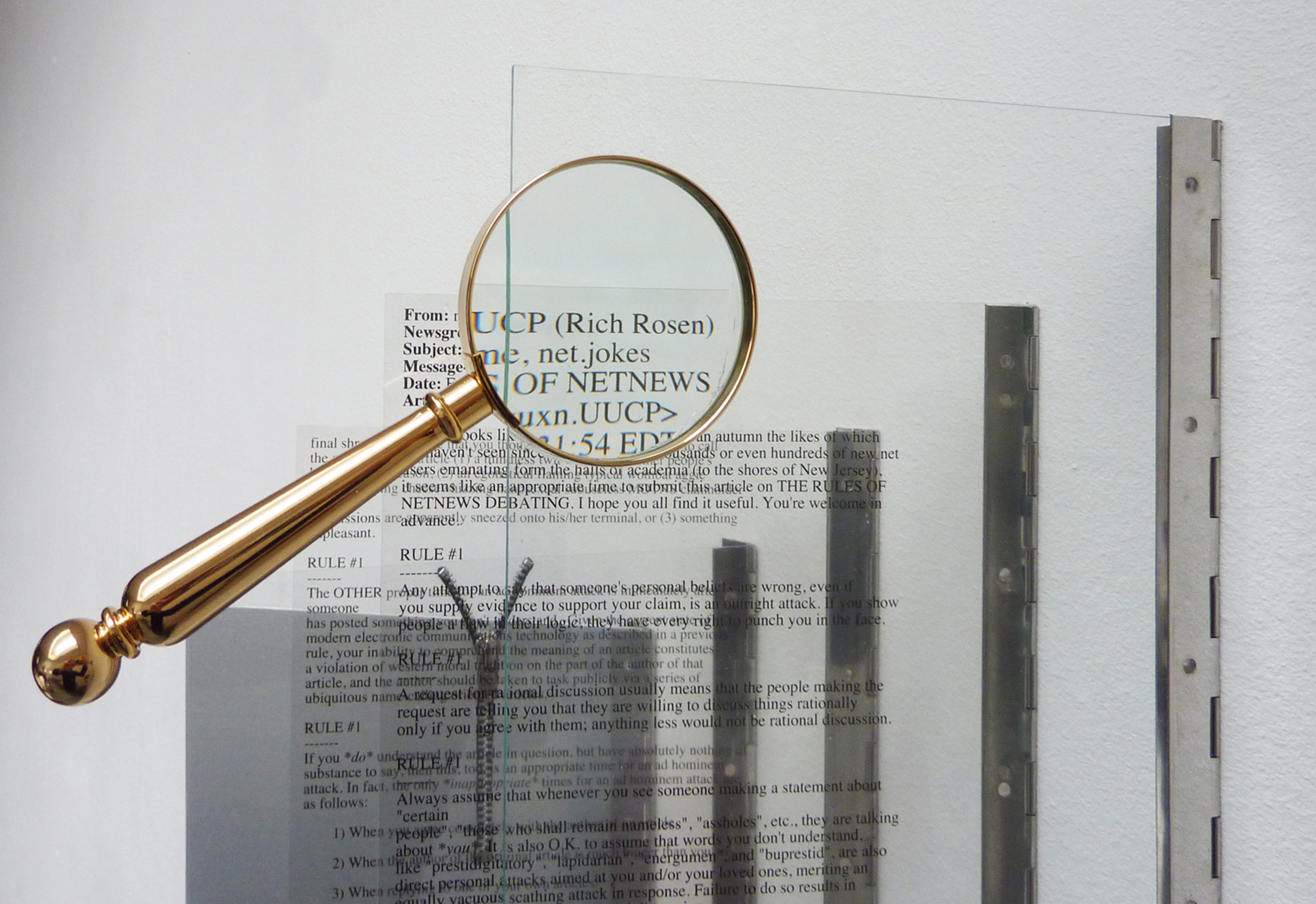 David Jablonowski's artwork, Rules of Netnews Debating (Rich Rosen, 1984), 2011. A magnifier over Rosen's text printed on glass