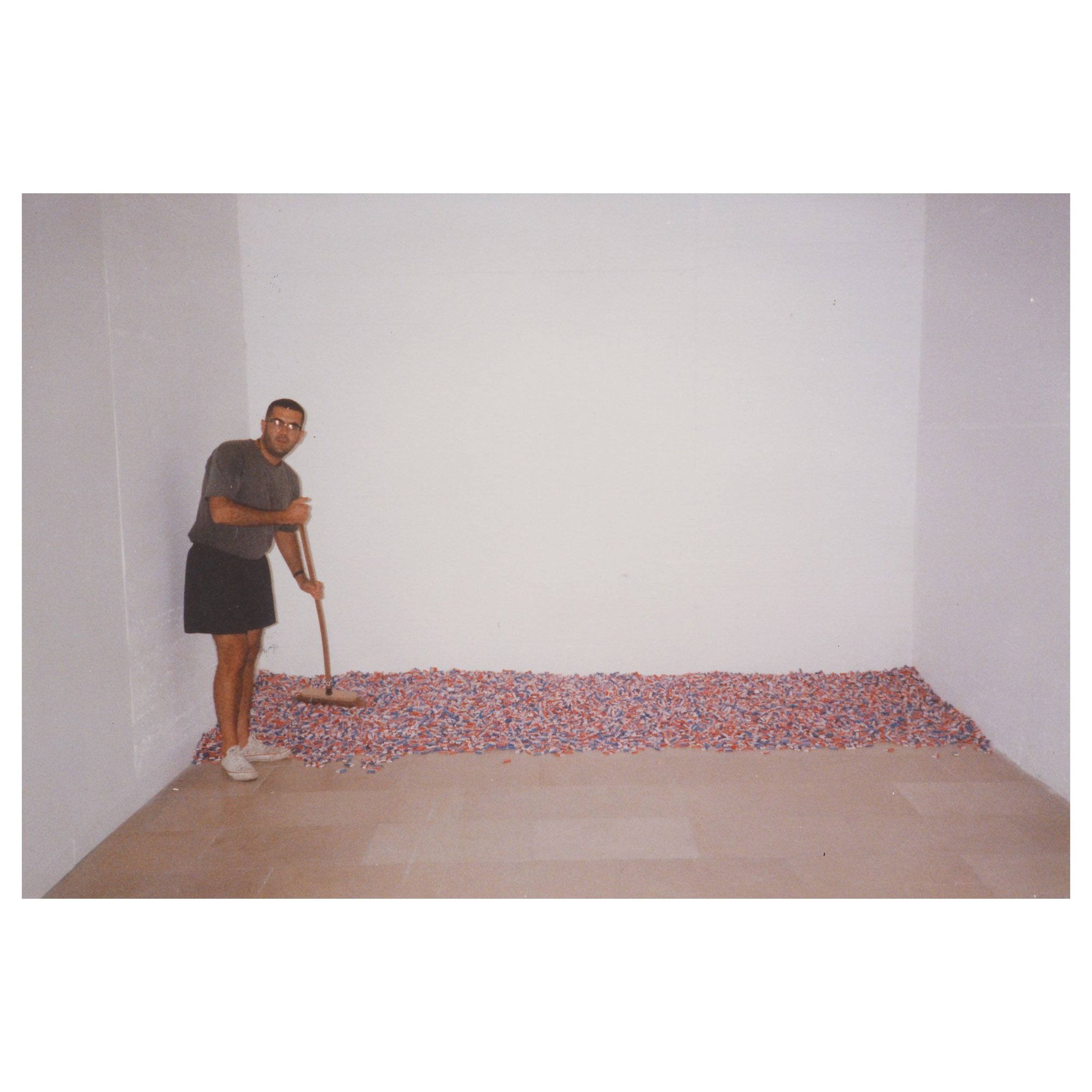 Félix Gonzalez-Torres sweeping the candies on the floor from his Untitled piece