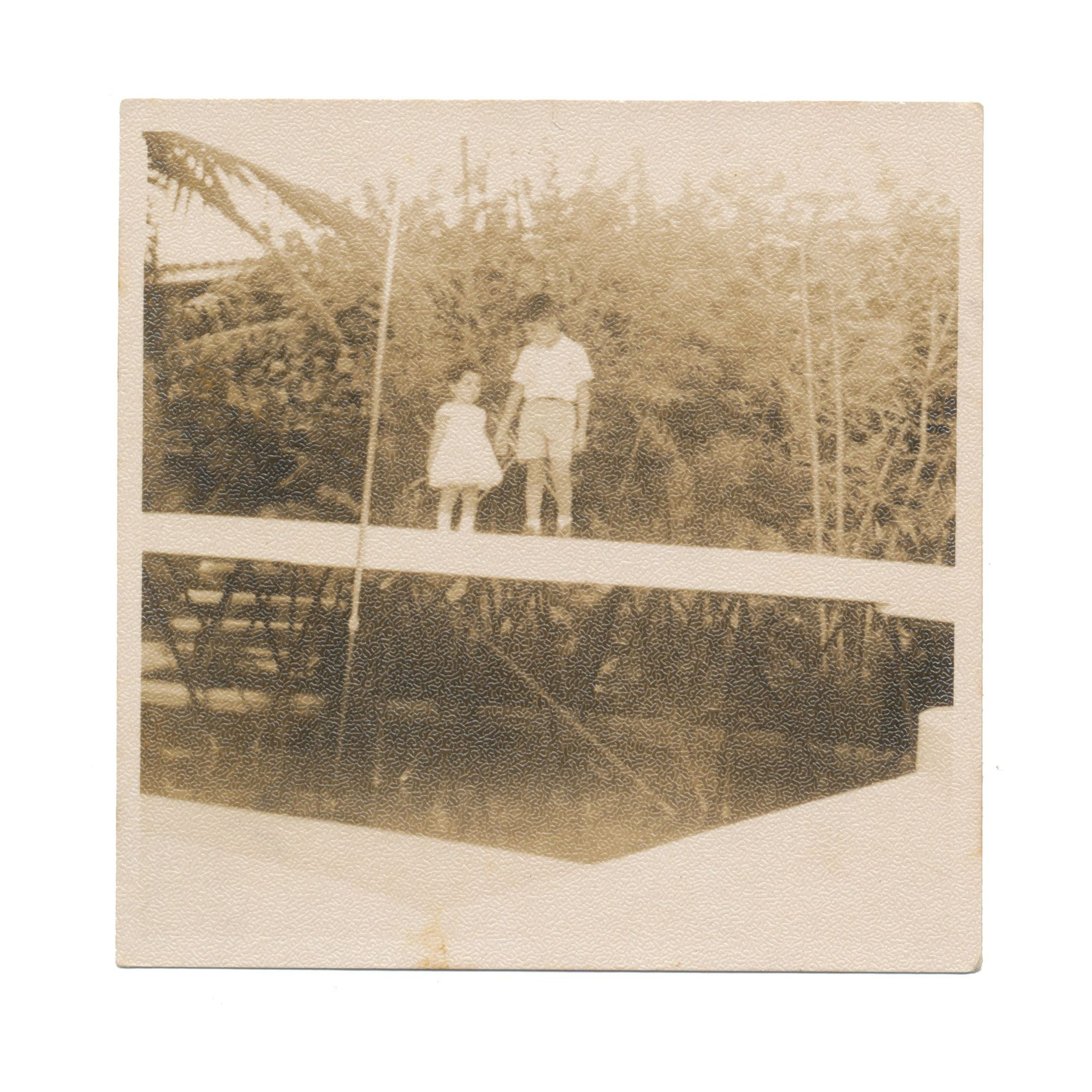 two little kids standing on a bridge