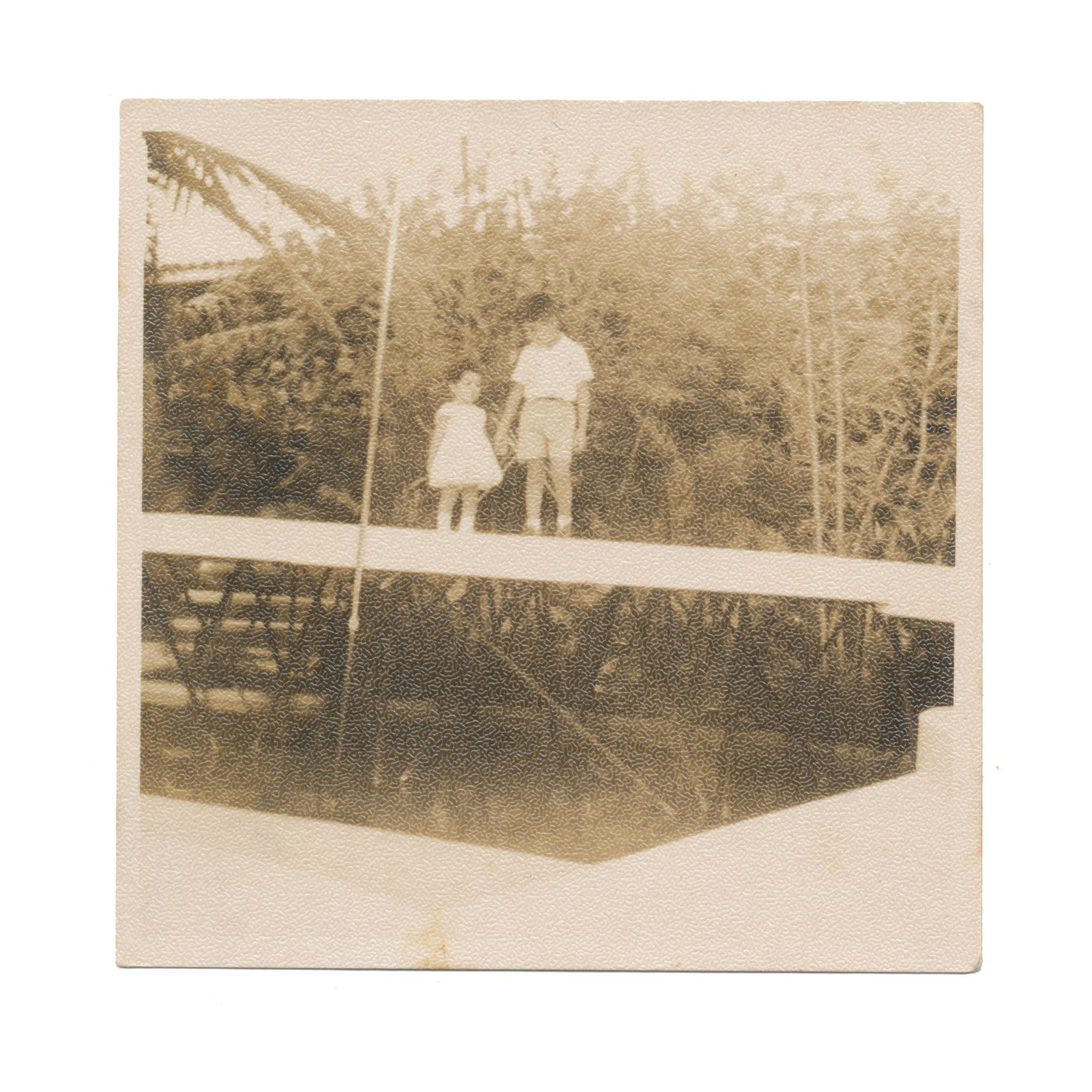 Felix standing with his sister on a bridge