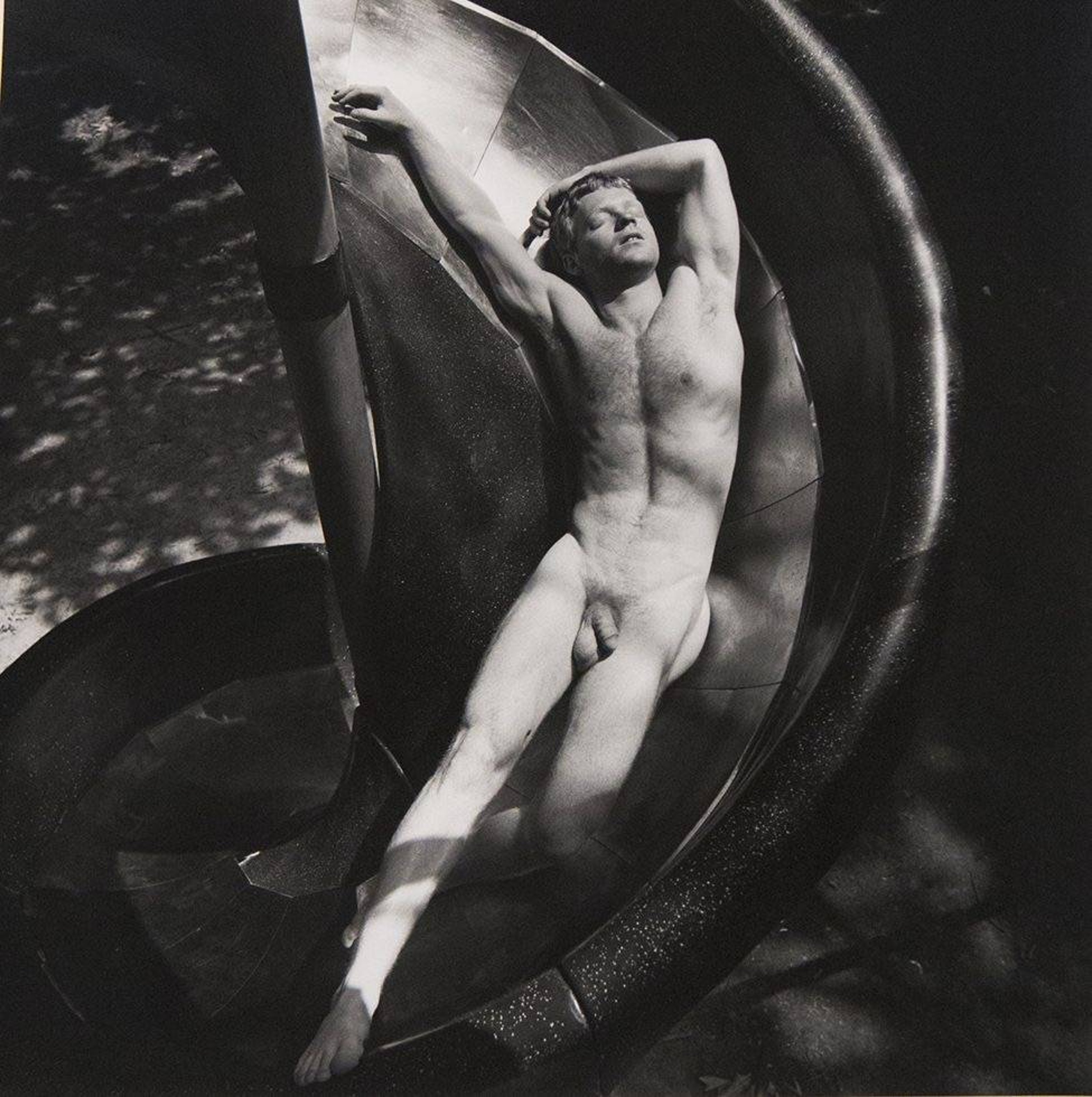 Black and white hotograph of a nude man on a slide
