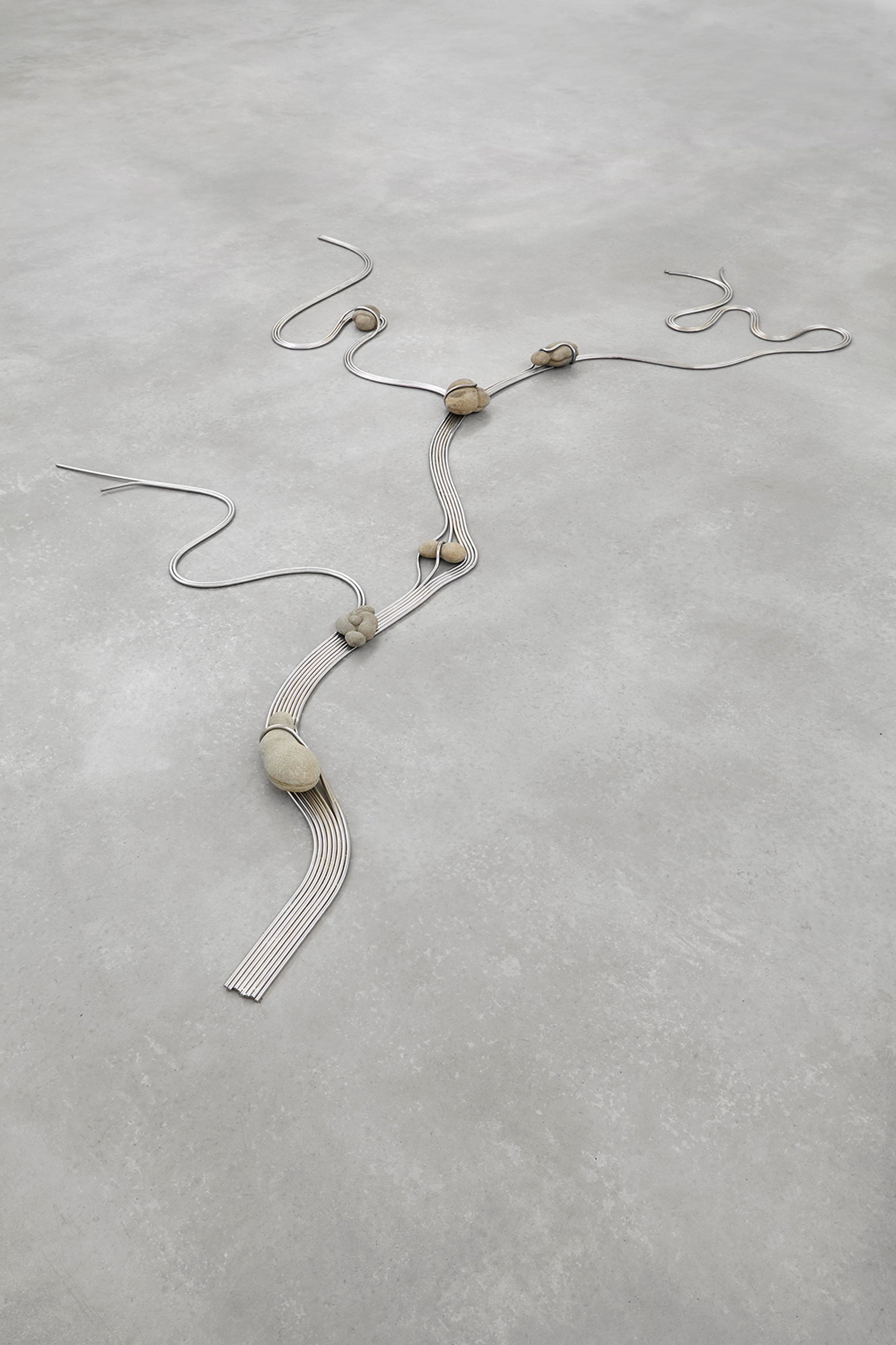 Rocks tied with metal wires on concrete flooring