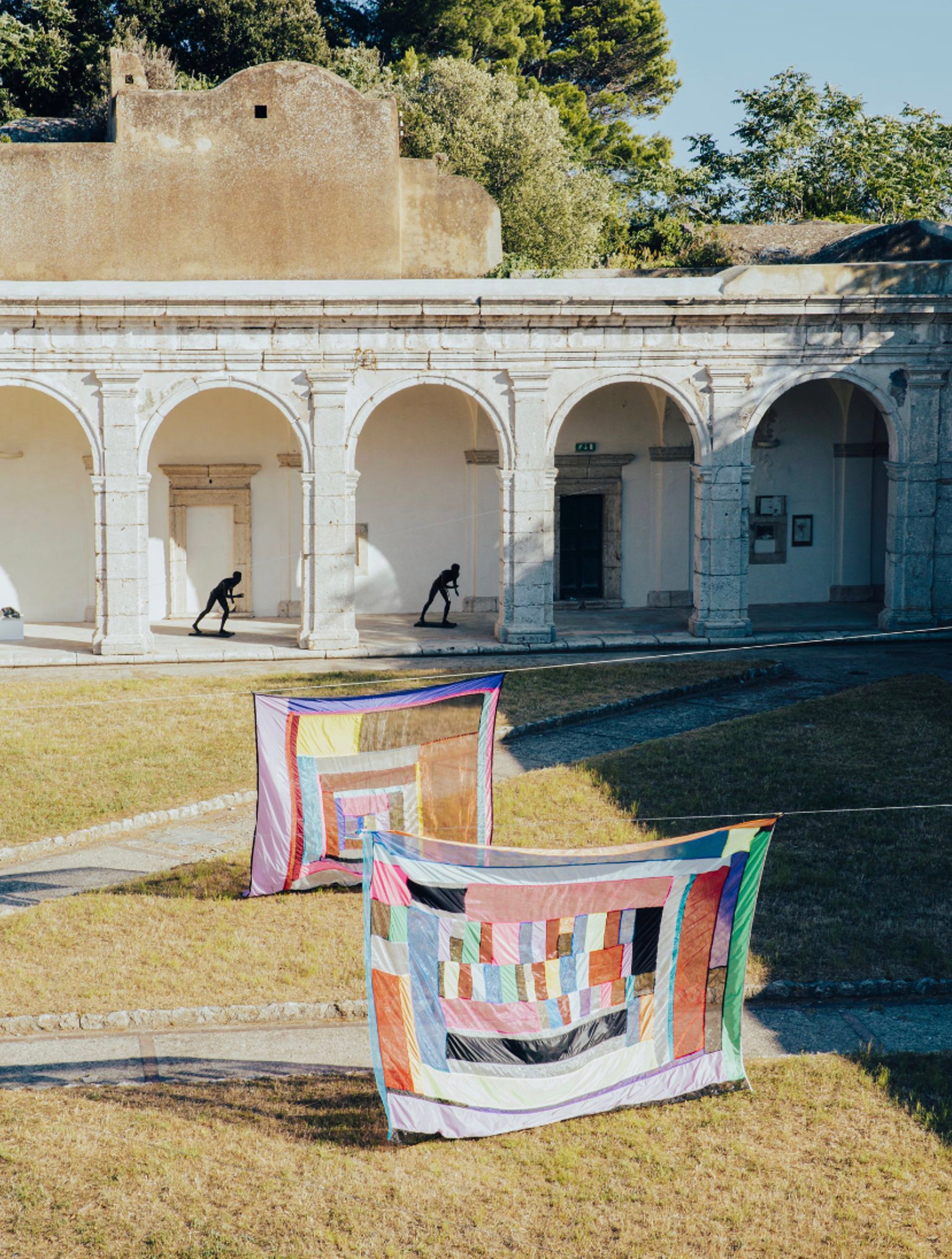 Garden-of-an-old-building-with-colorful-artworks-on-display