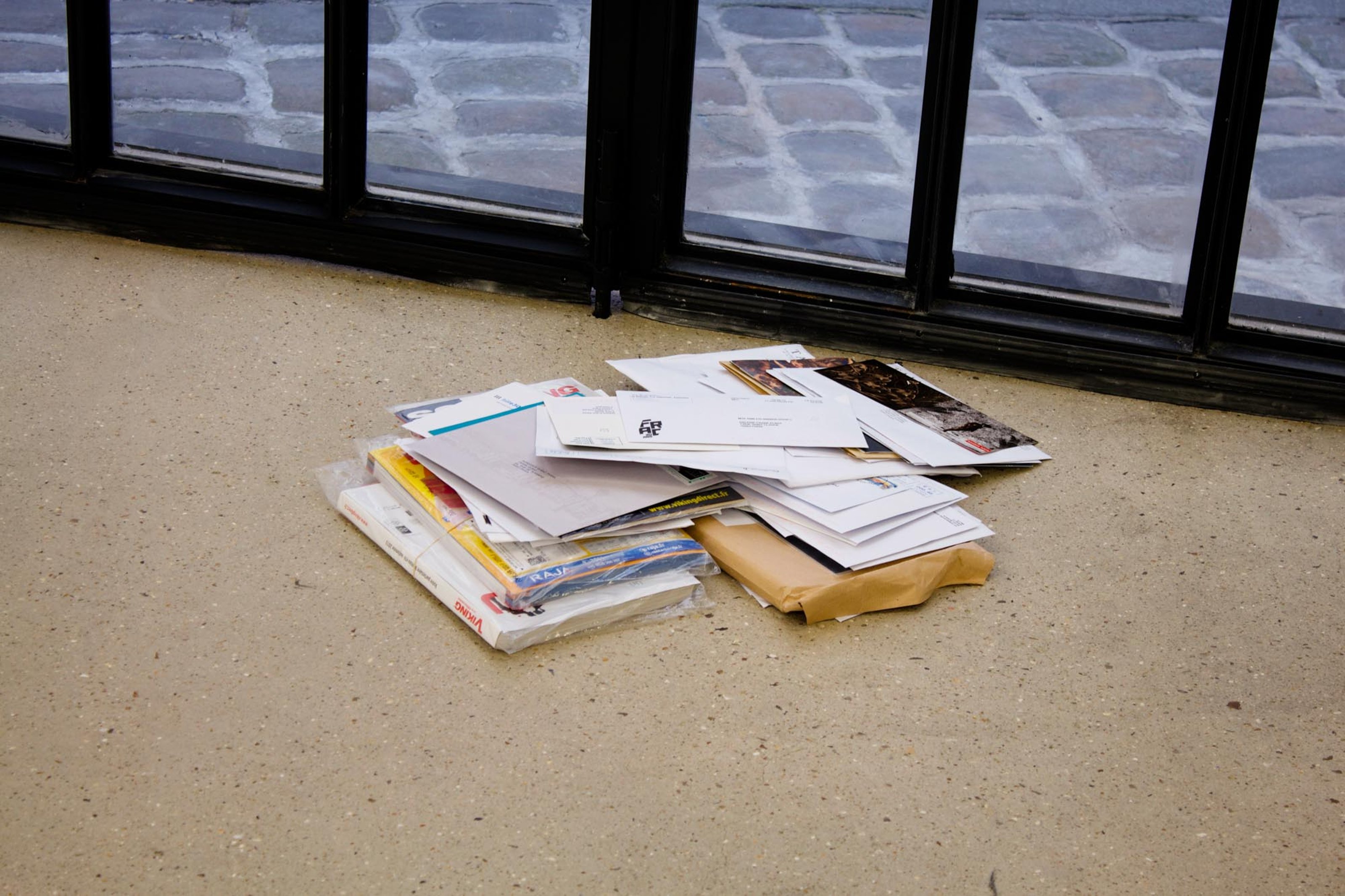 Gallery mail accumulated at the door, unopened for the exhibition duration.